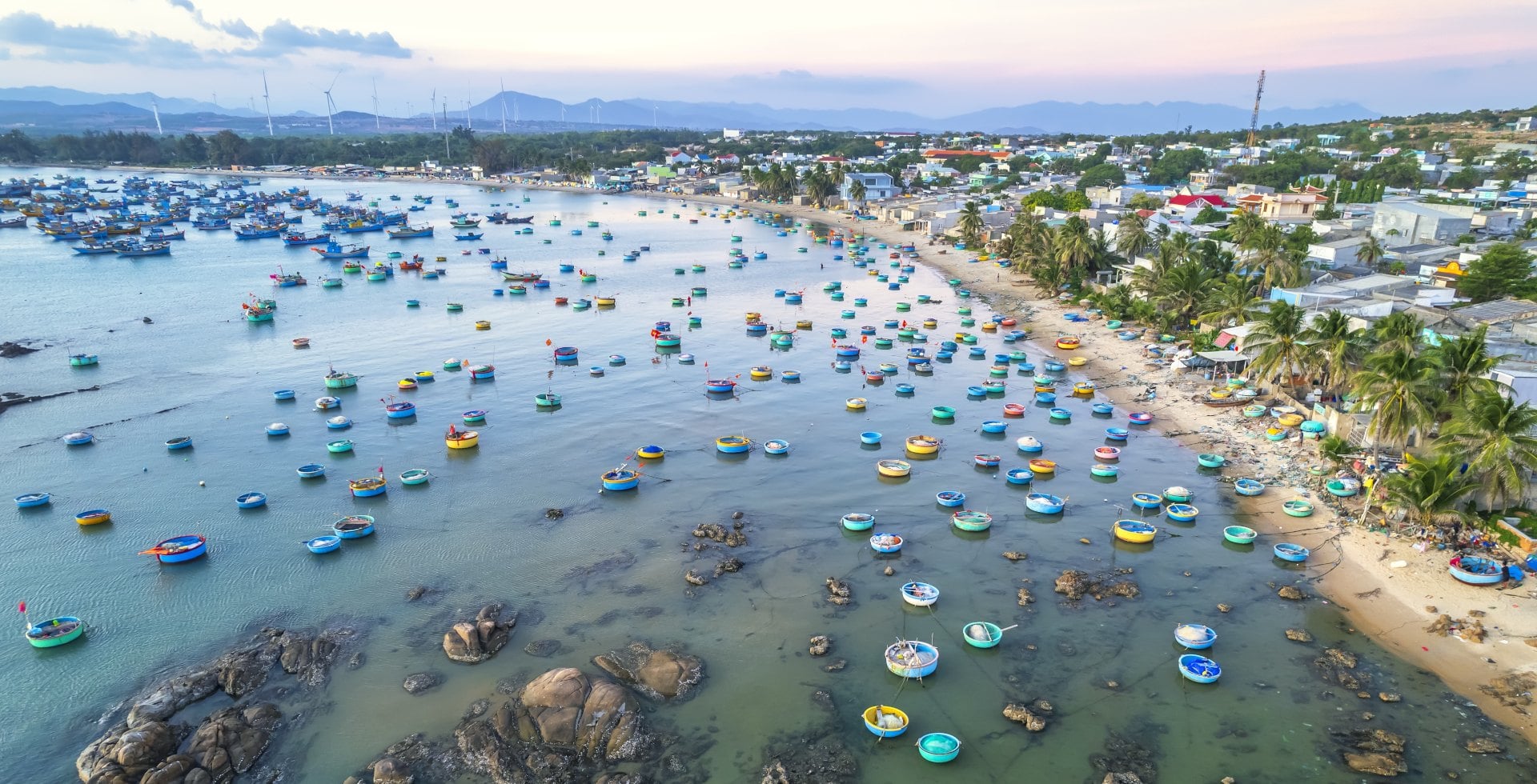 "Aerial view of Mui Ne fishing village in the morning with hundreds of boats anchored to avoid storms"