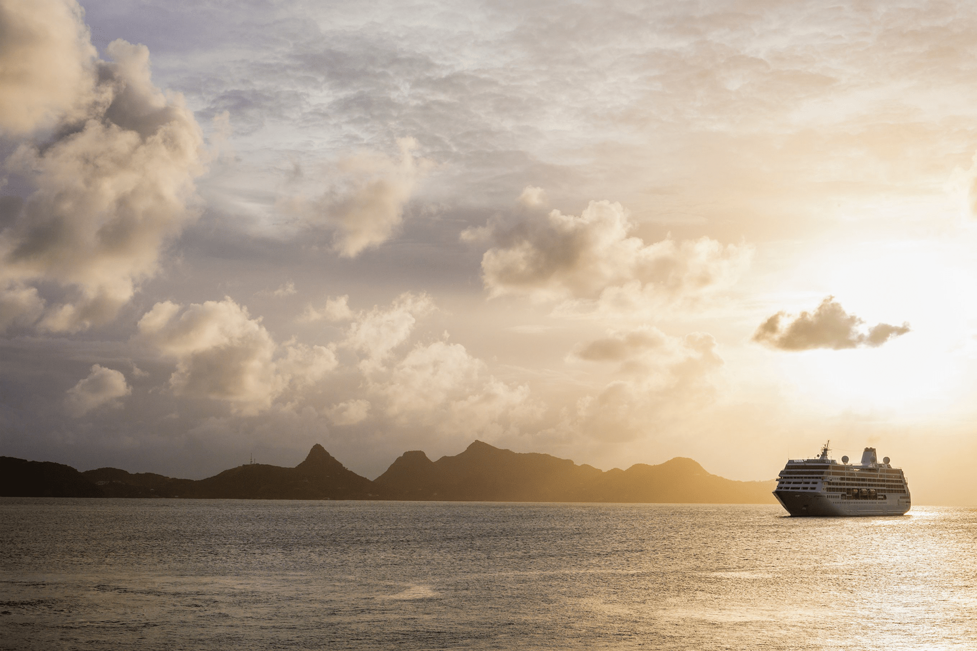Cruise ship moored off Mayreau Island, one of the Grenadines. The island in the background is Union Island.