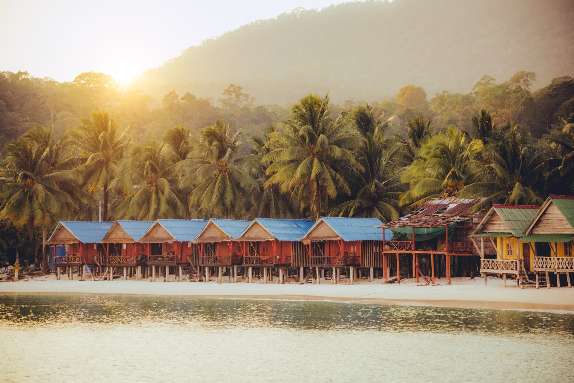 Elevated bungalows along beach with lush palm trees on the secluded Island Koh Rong Sanloem, Sihanoukville Province, Cambodia