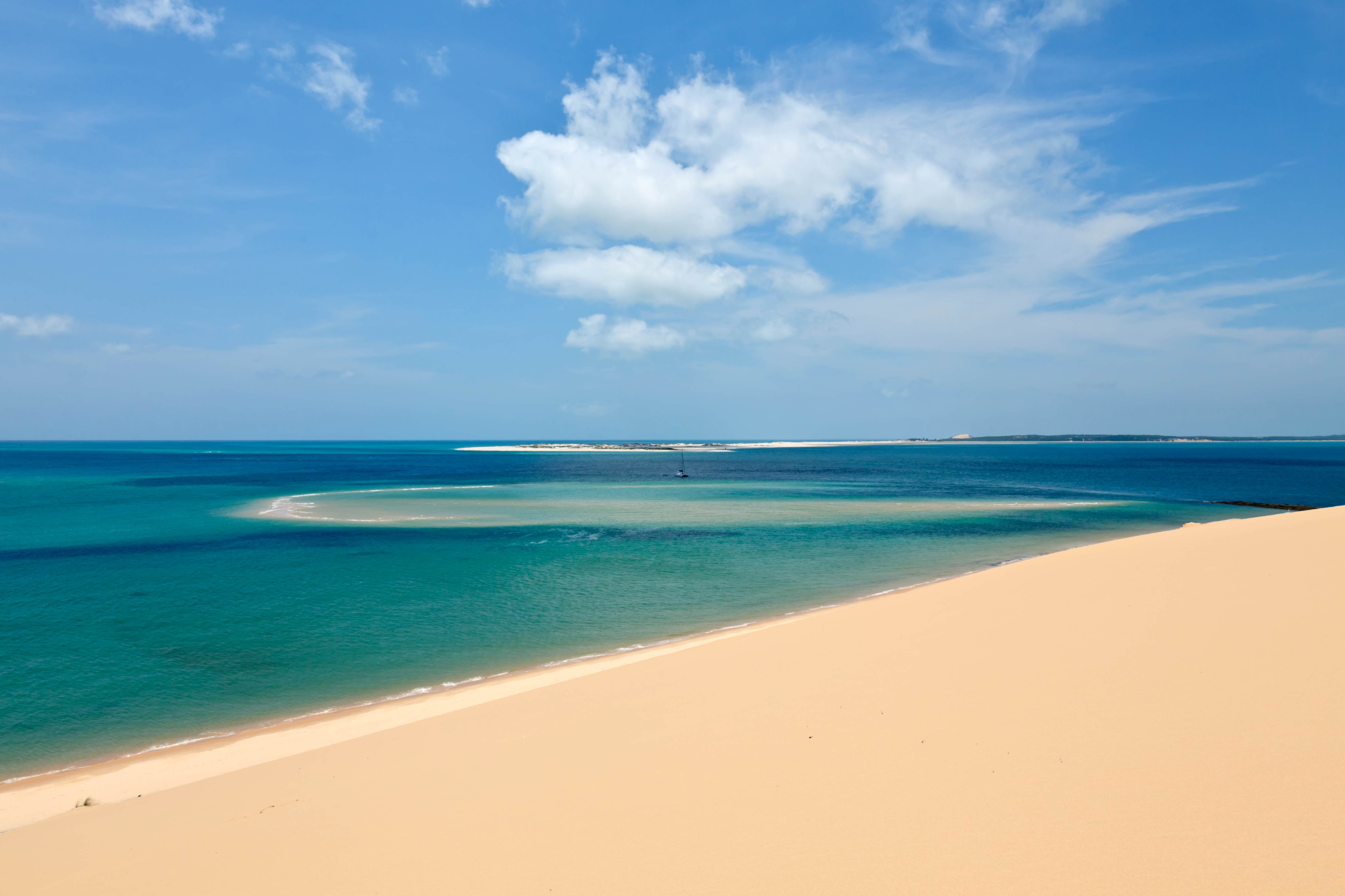 View from a sandune in the Bazaruto archipelago Mozambique with a luxury yacht lying at anchor below. 