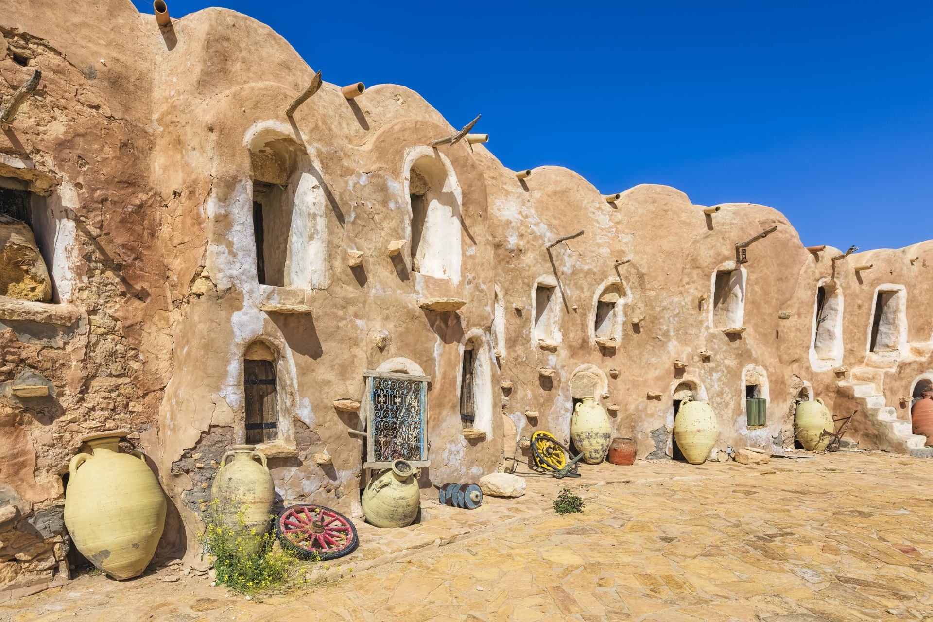 Ksar Ouled Debbab, a traditional fortified granary in Tunisia. The Ksar is made up of a cluster of beehive-shaped stone huts, which were used to store grain and other food supplies.