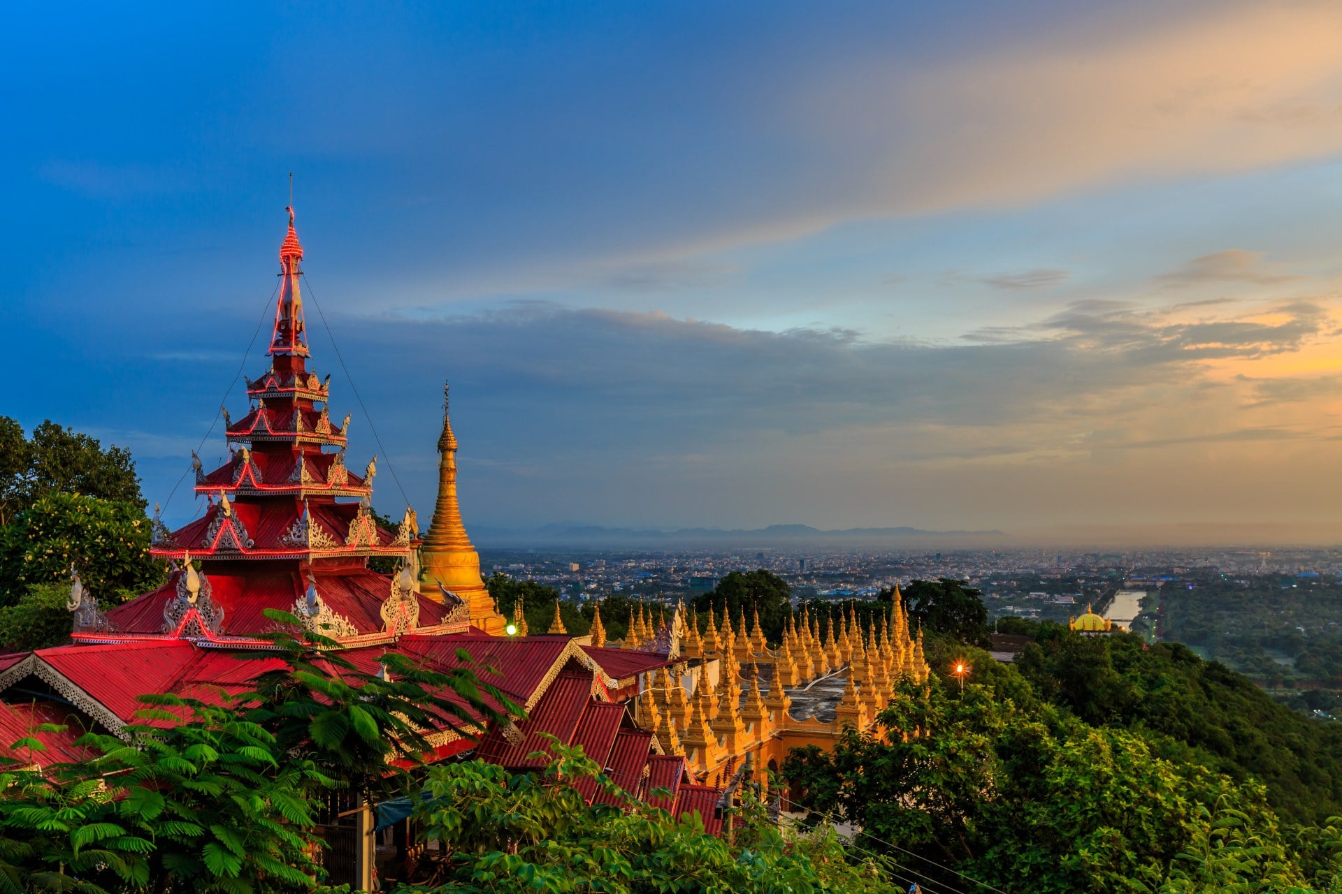HIllside view of the red roof of Mandalay Palace and Hill