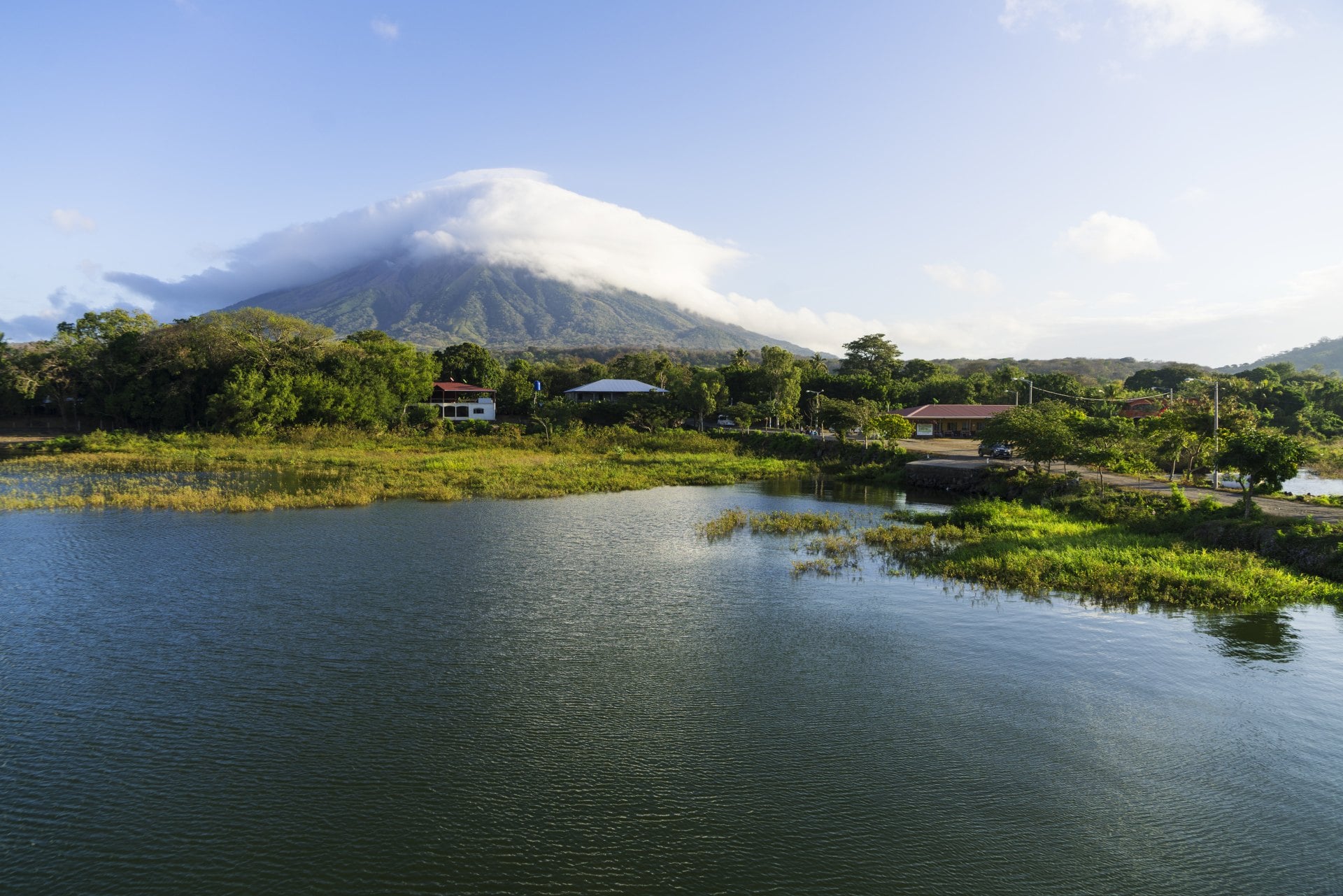 Morning view from Lake Nicaragua to island Ometepe and volcano Concepcion with white clouds on it