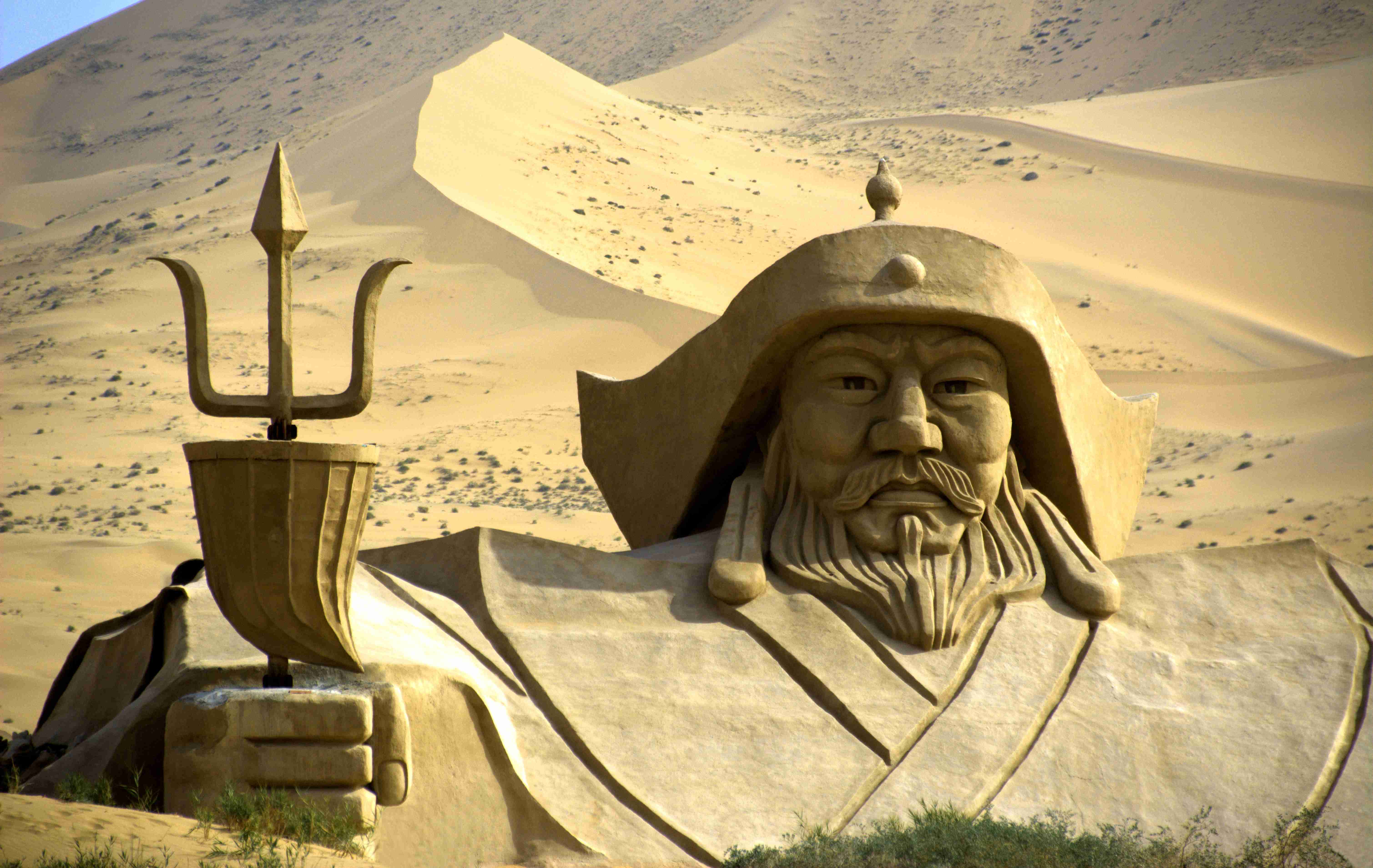 Genghis Khan statue in the middle of Badain Jaran desert. This desert is home to some of the tallest stationary dunes on Earth