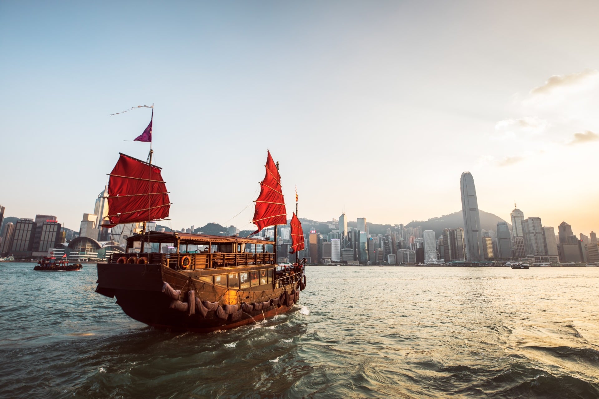Victoria Harbour Traditional junk boat crossing Victoria Harbour in Hong Kong