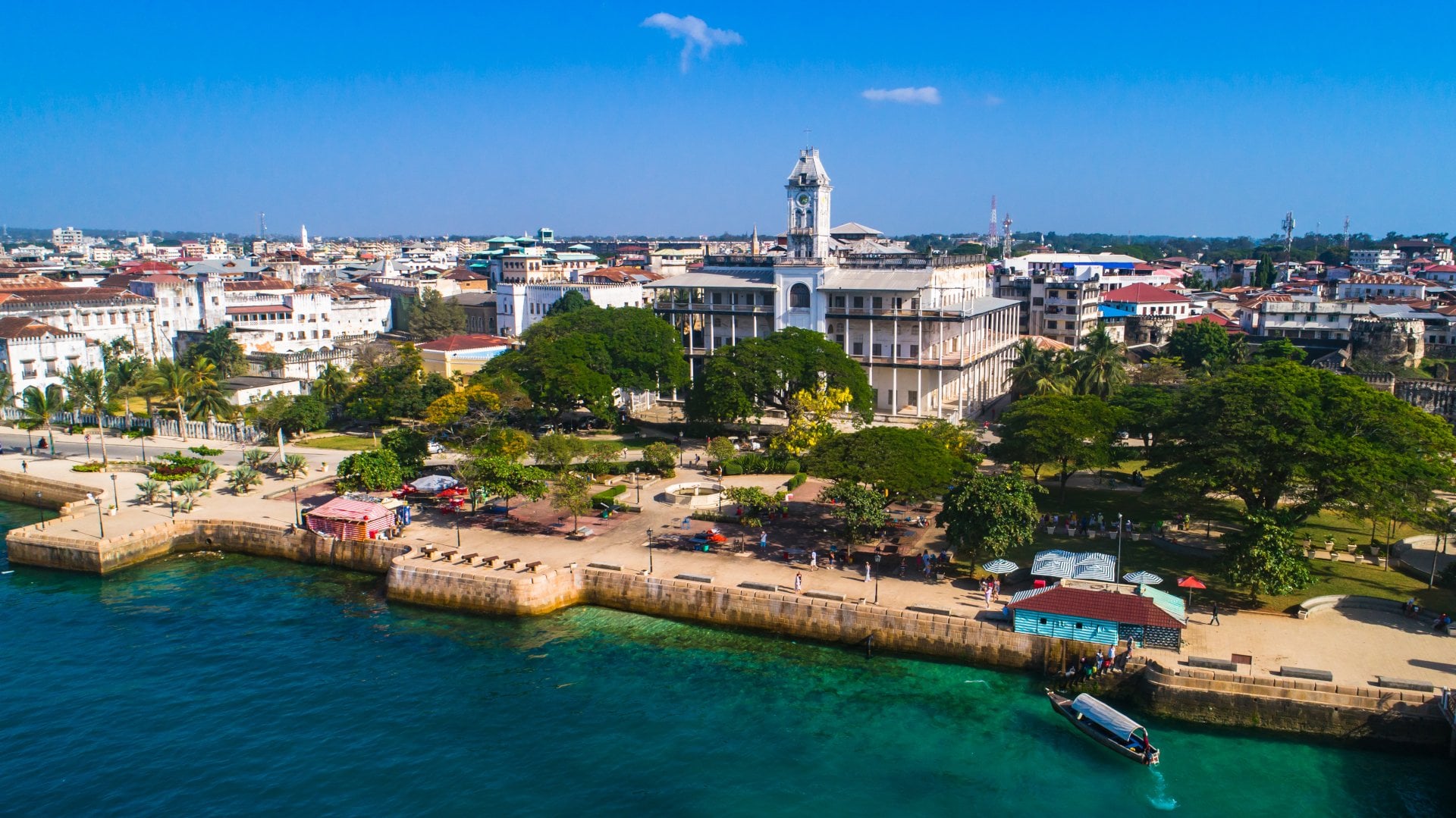 A bird's-eye view of Stone Town, captures the essence of this historic coastal city, its vibrant streets and ancient landmarks intertwined with the azure embrace of the Indian Ocean.