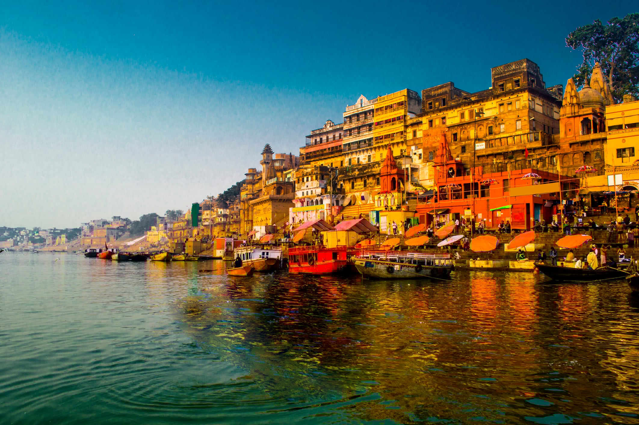 View of the Ganges River during the morning with intense colour shitting the shoreline of Varanasi, India