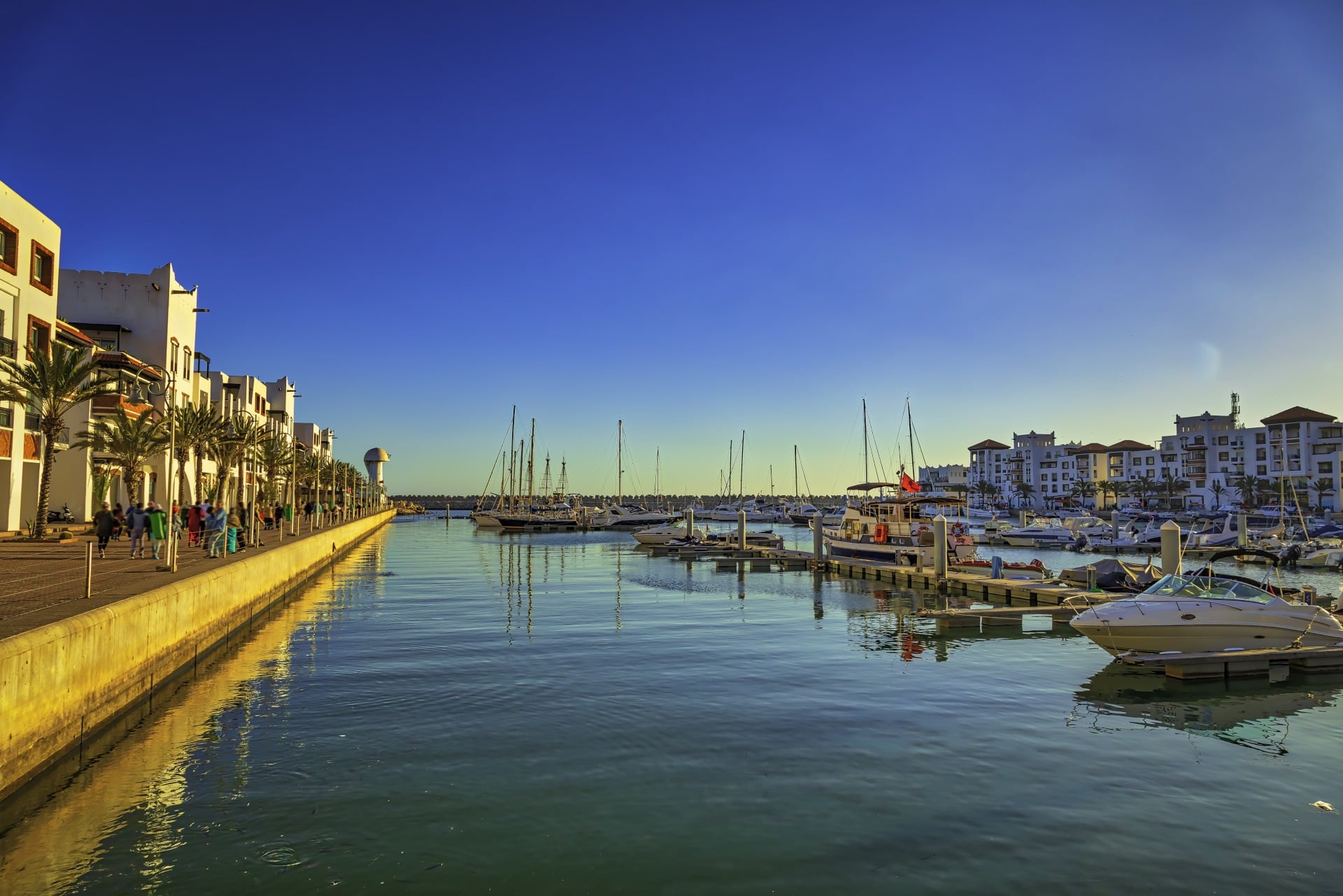 marina with boats and old buildings along the sea