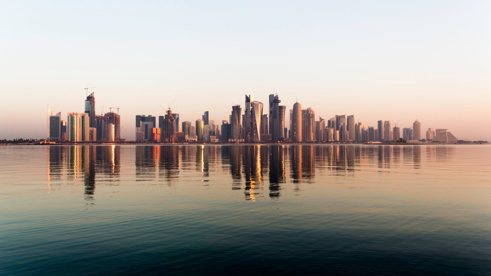 Early morning sunrise golden light hits the city of Doha