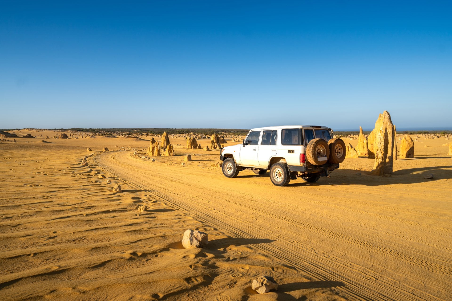 Four-wheel-drive car in the Pinnacles Desert, Nambung National Park, Western Australia.
