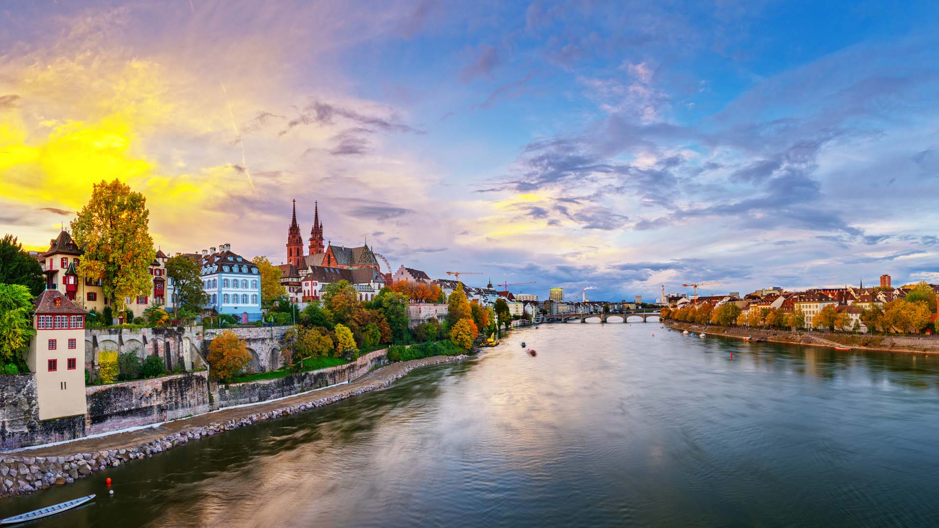 Panoramic view of the Rhine River passing through Basel in Switzerland at sunset