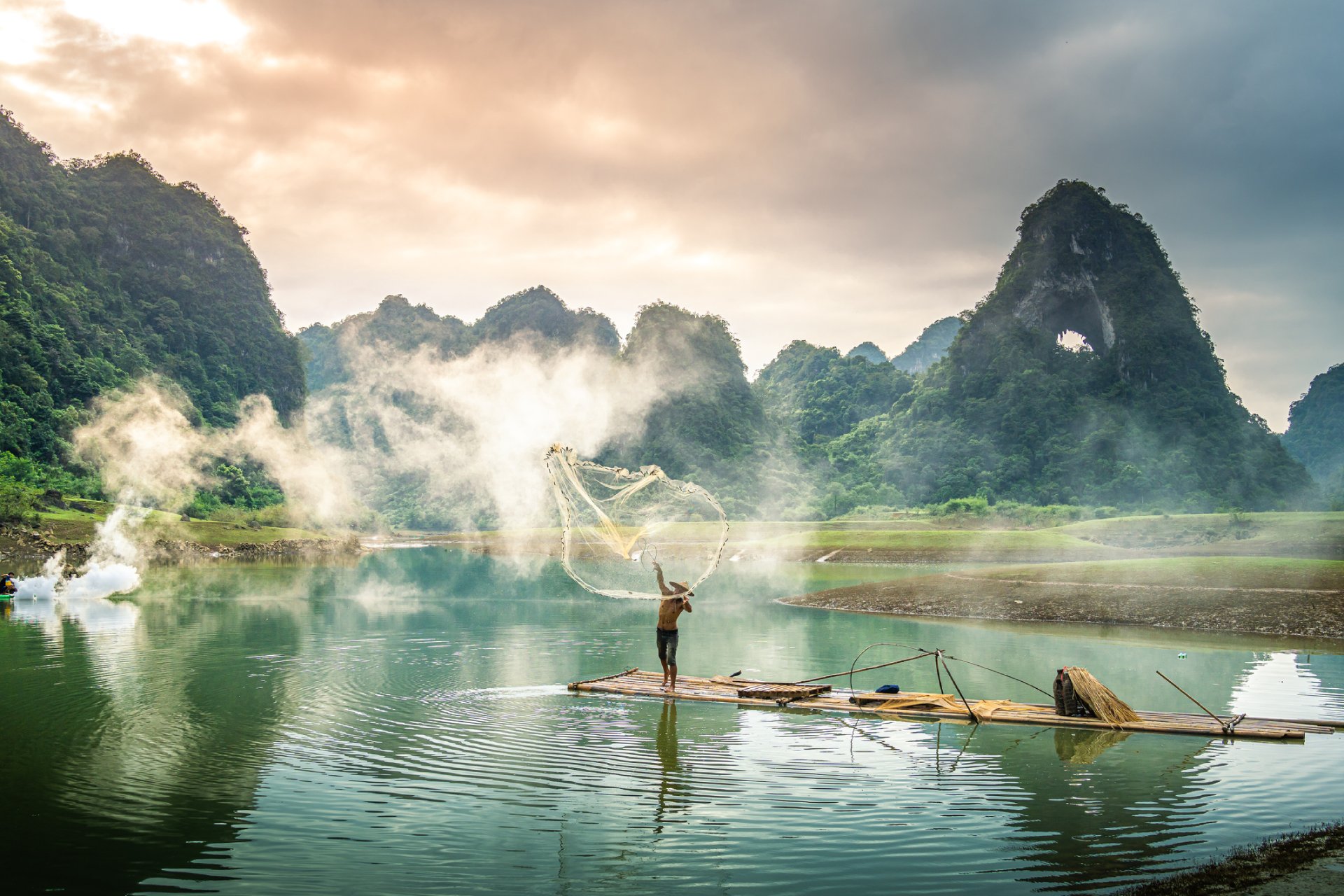 View of fishermen fishing on river in Thung mountain in Tra Linh