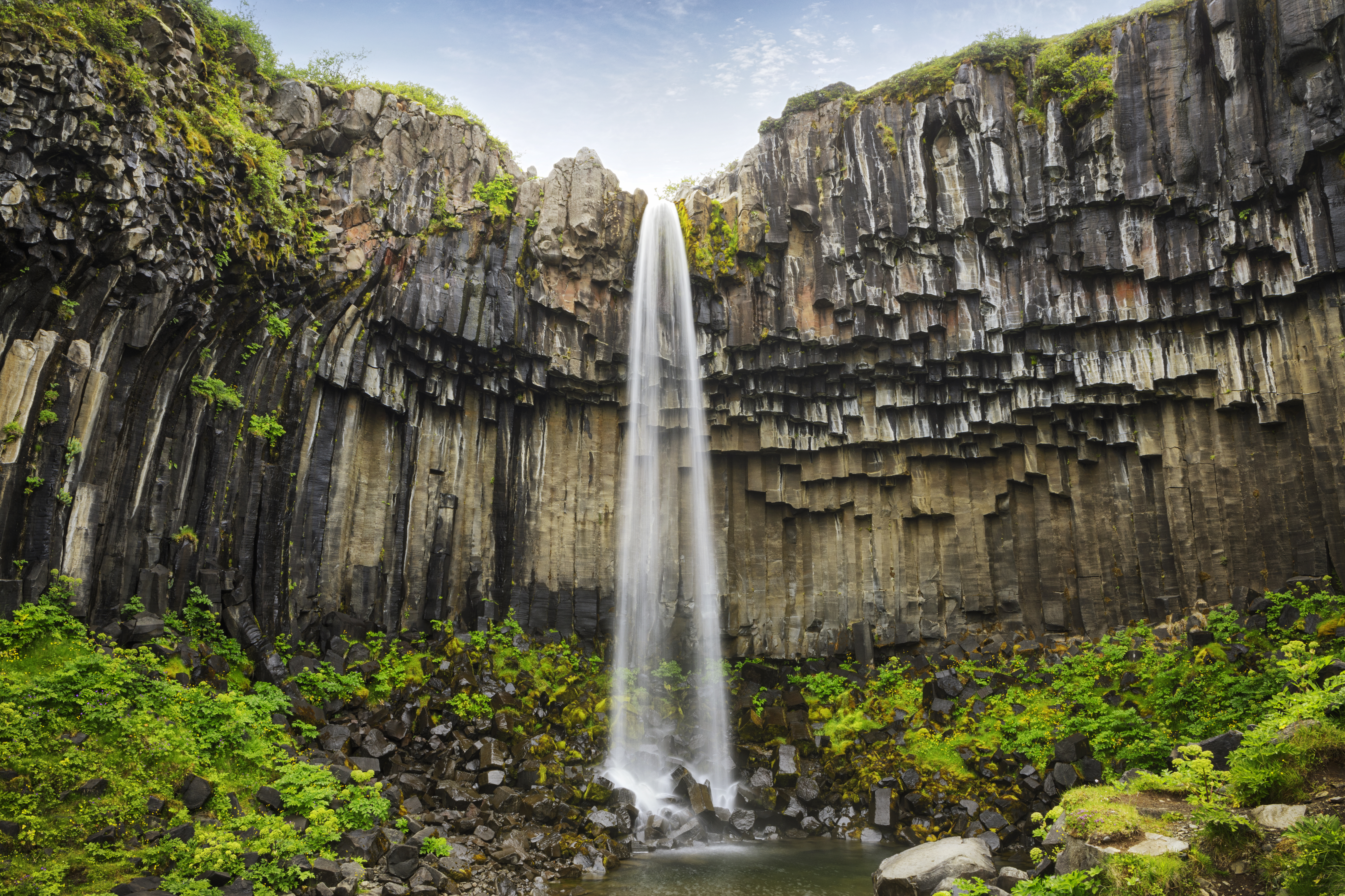 Svartifoss Waterfall in Iceland near Vatnajokull glacier, famous for its wide basalt stone wall.