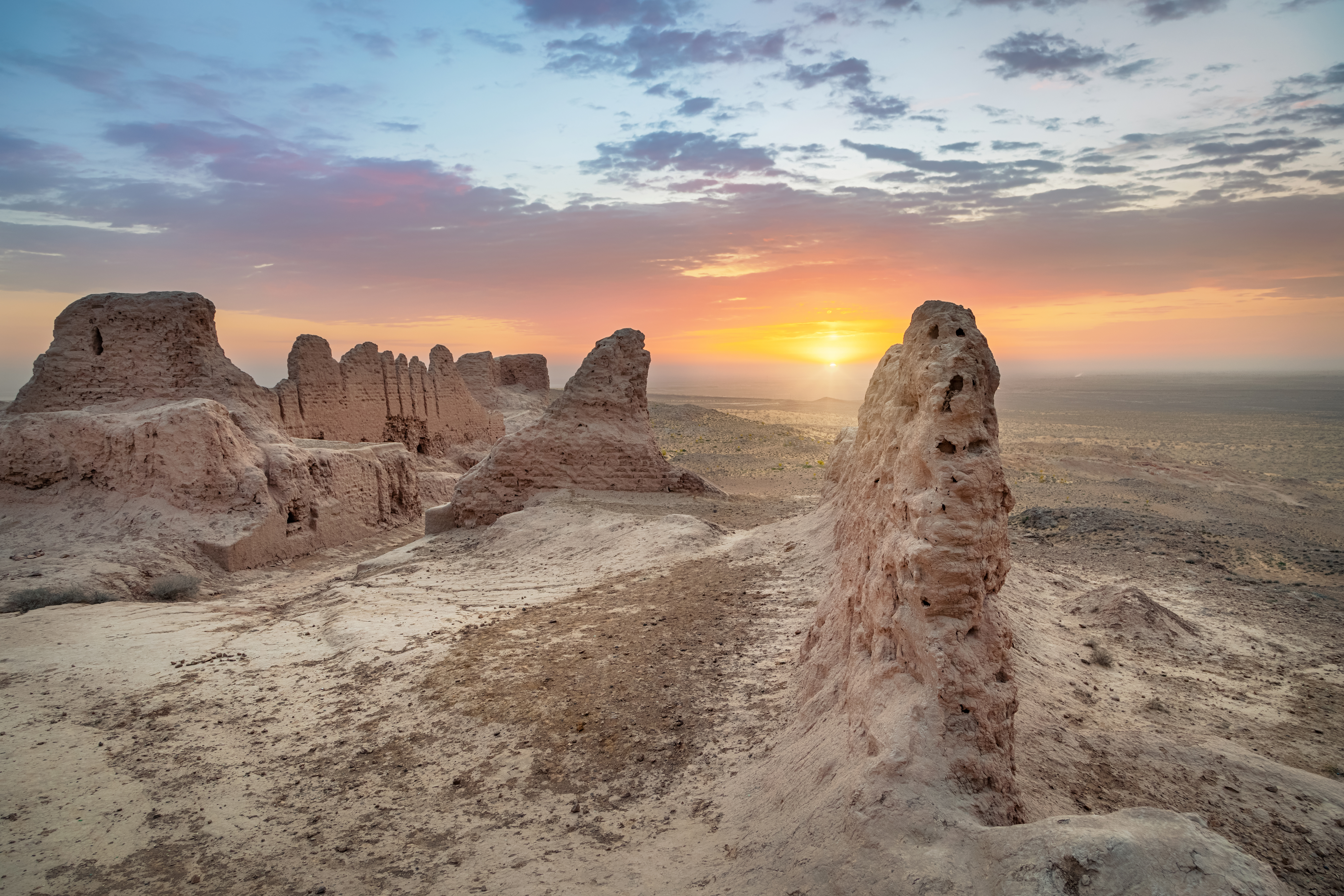 Ruins of ancient Khorezm fortress Ayaz Kala in Kyzylkum desert on sunrise