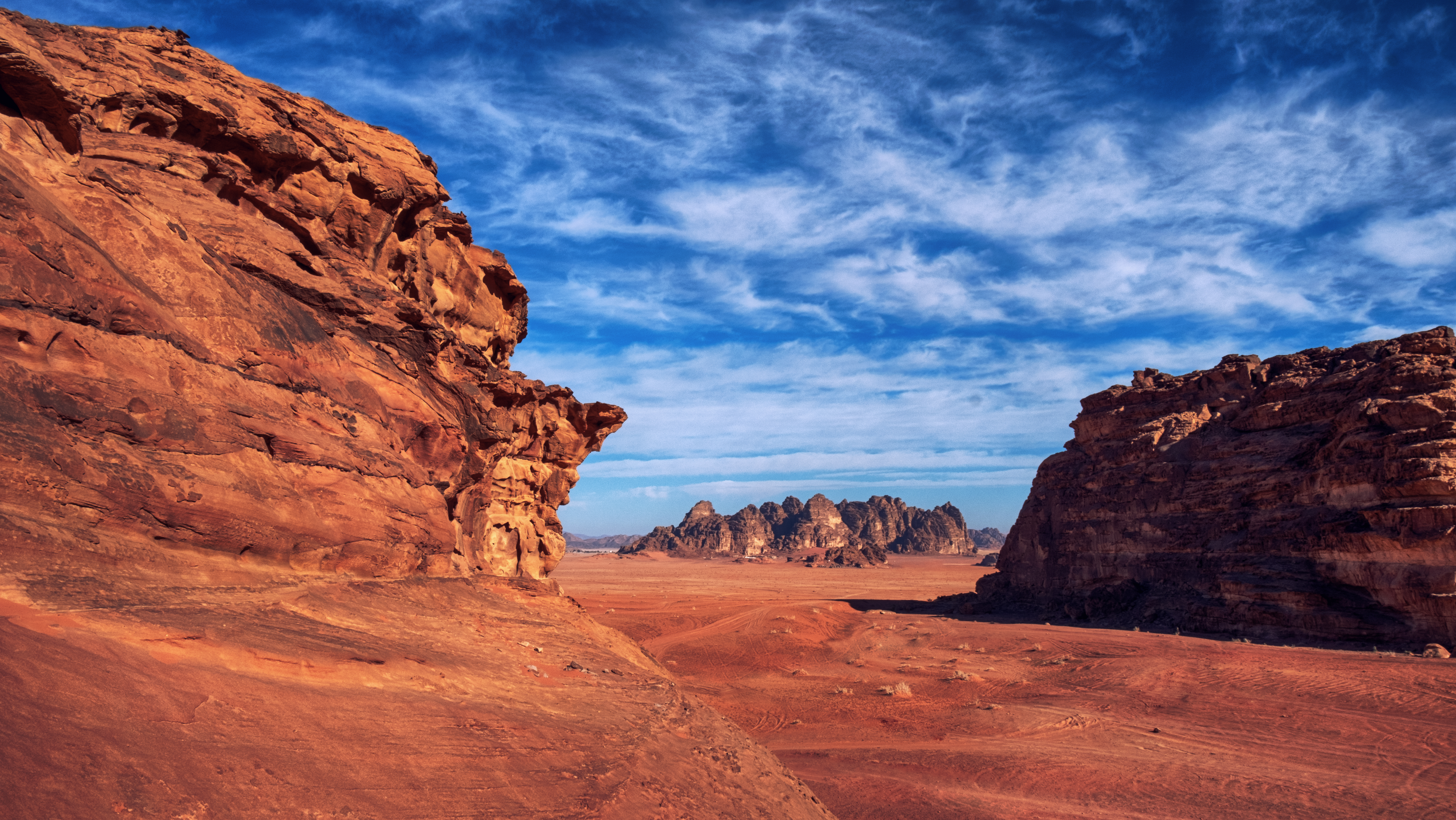 Wadi Rum, known also as the Valley of the Moon , is a valley cut into the sandstone and granite rock