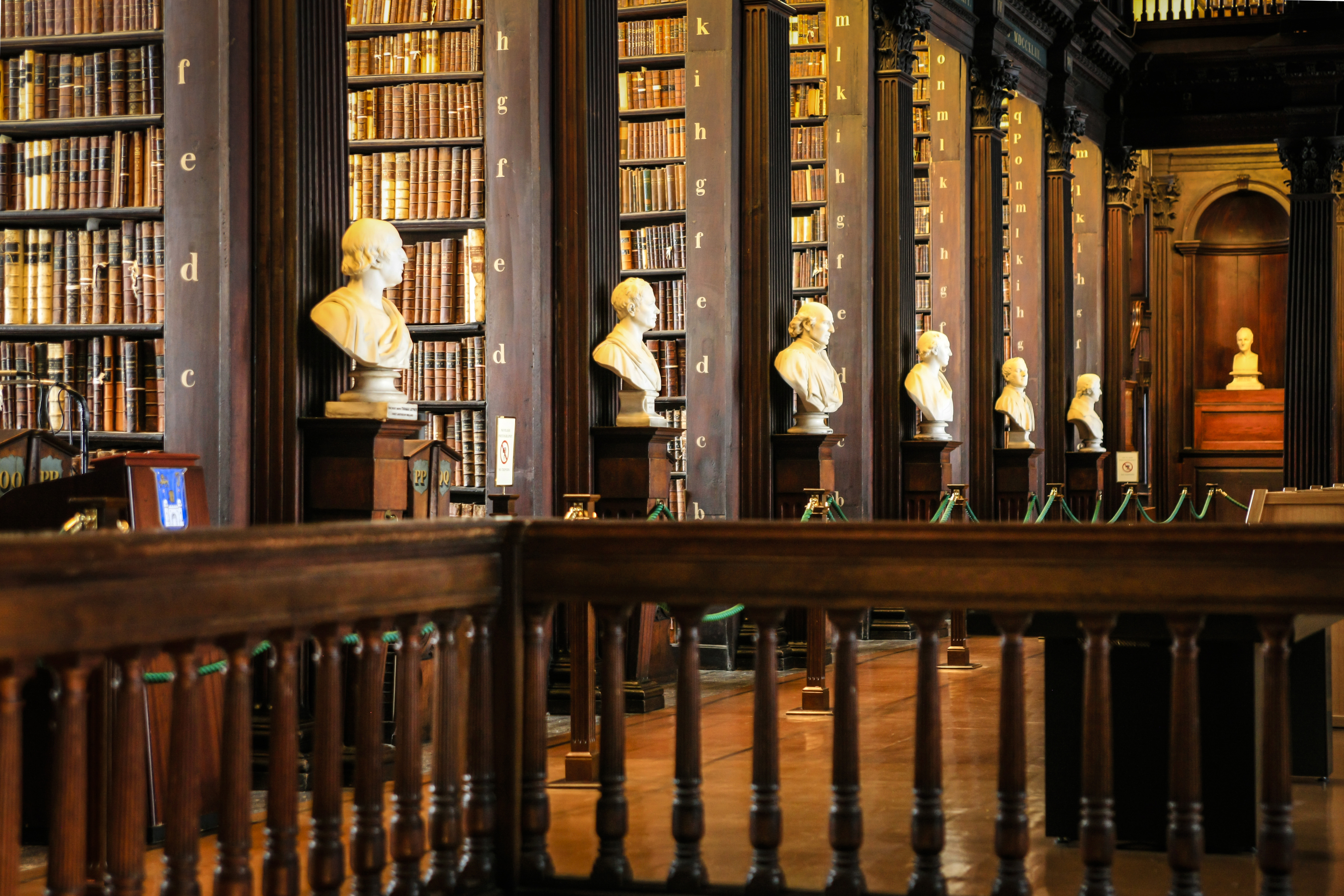 Thousands of books on shelves inside the Trinity College Library Dublin, Part of the University of Dublin