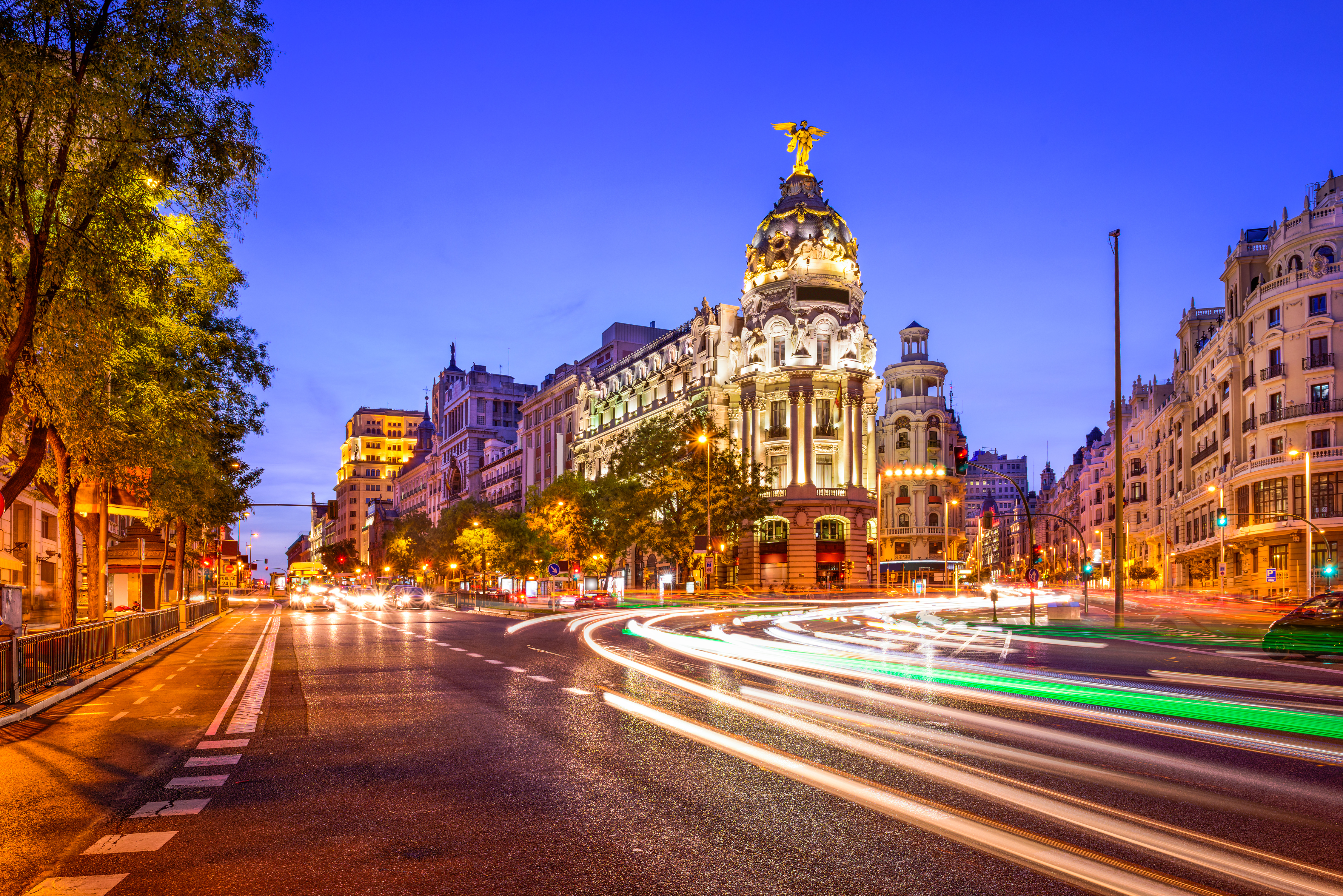 Rays of traffic lights on Gran via street, main shopping street in Madrid at night. Spain, Europe.