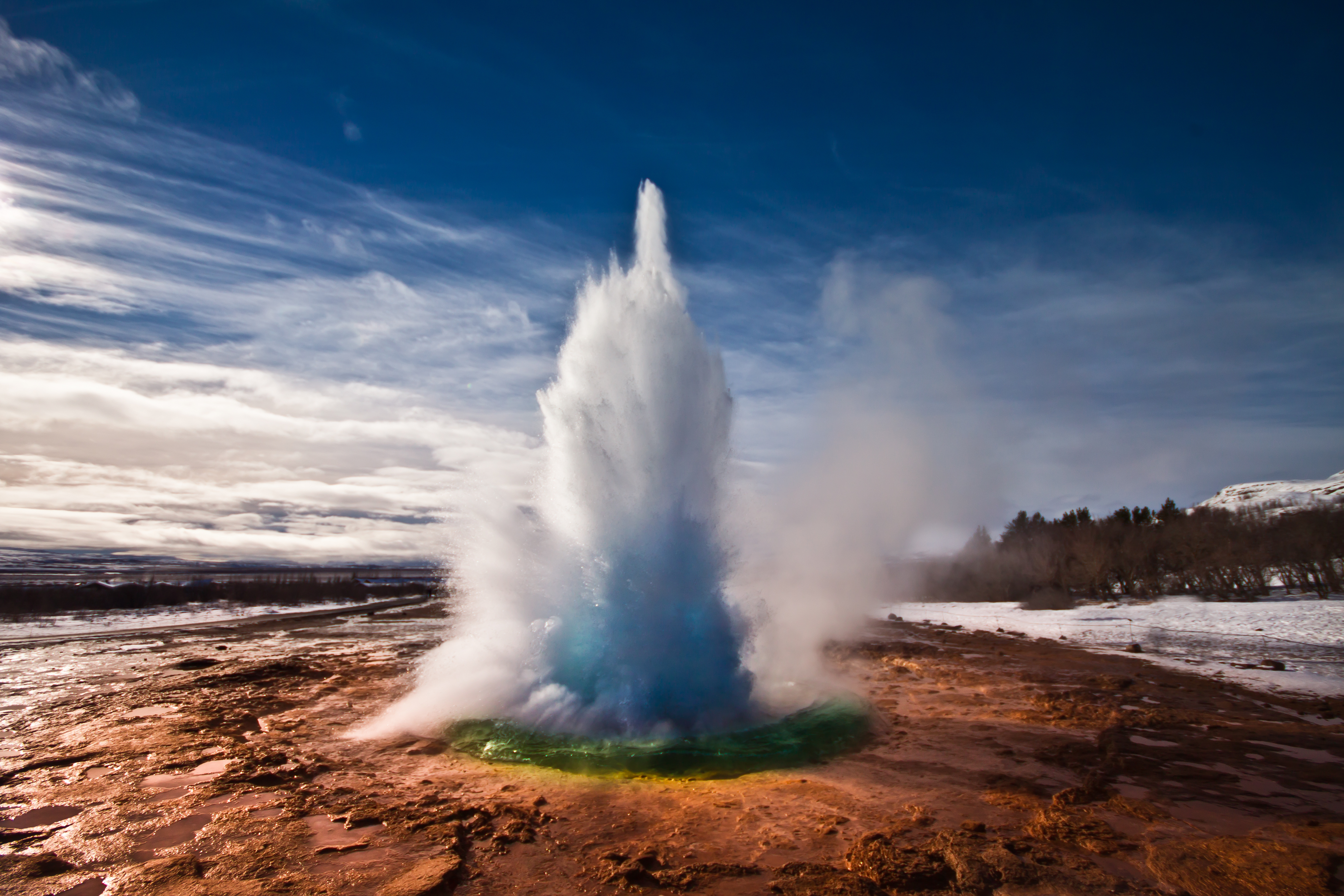 Erupting Strokkur Geyser on a sunny day in Iceland.