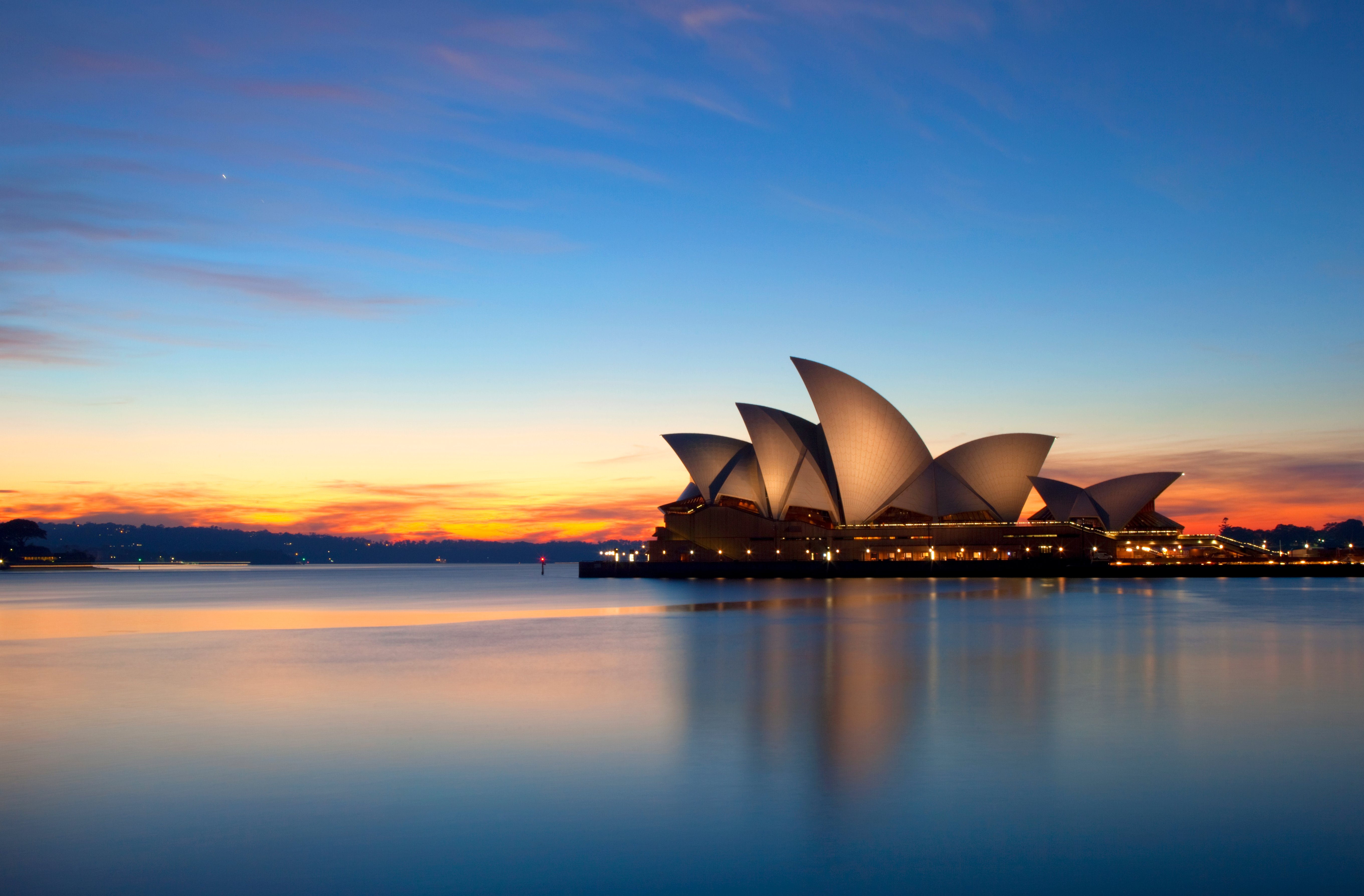 Pre-dawn sunlight lights up the sky over Sydney, Australia.