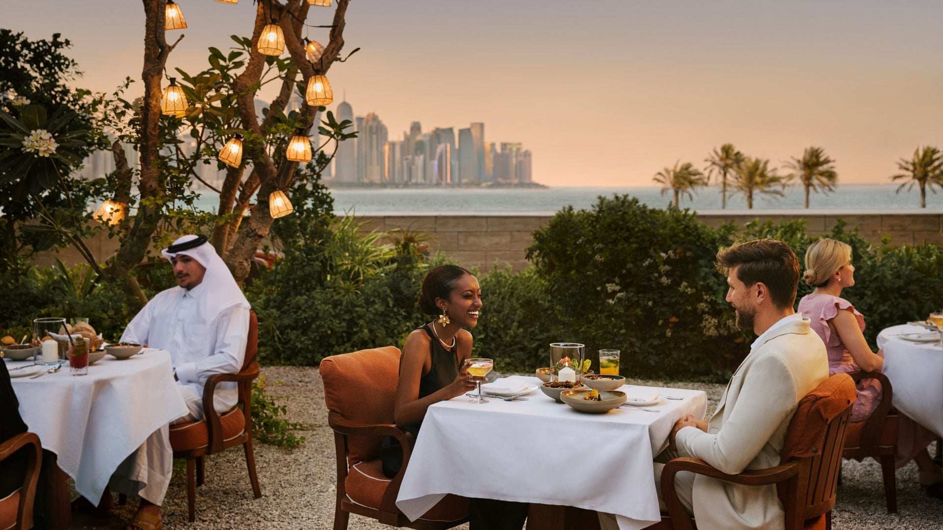 A couple enjoying a luxury meal at a seaside restaurant in the Qatari capital of Doha