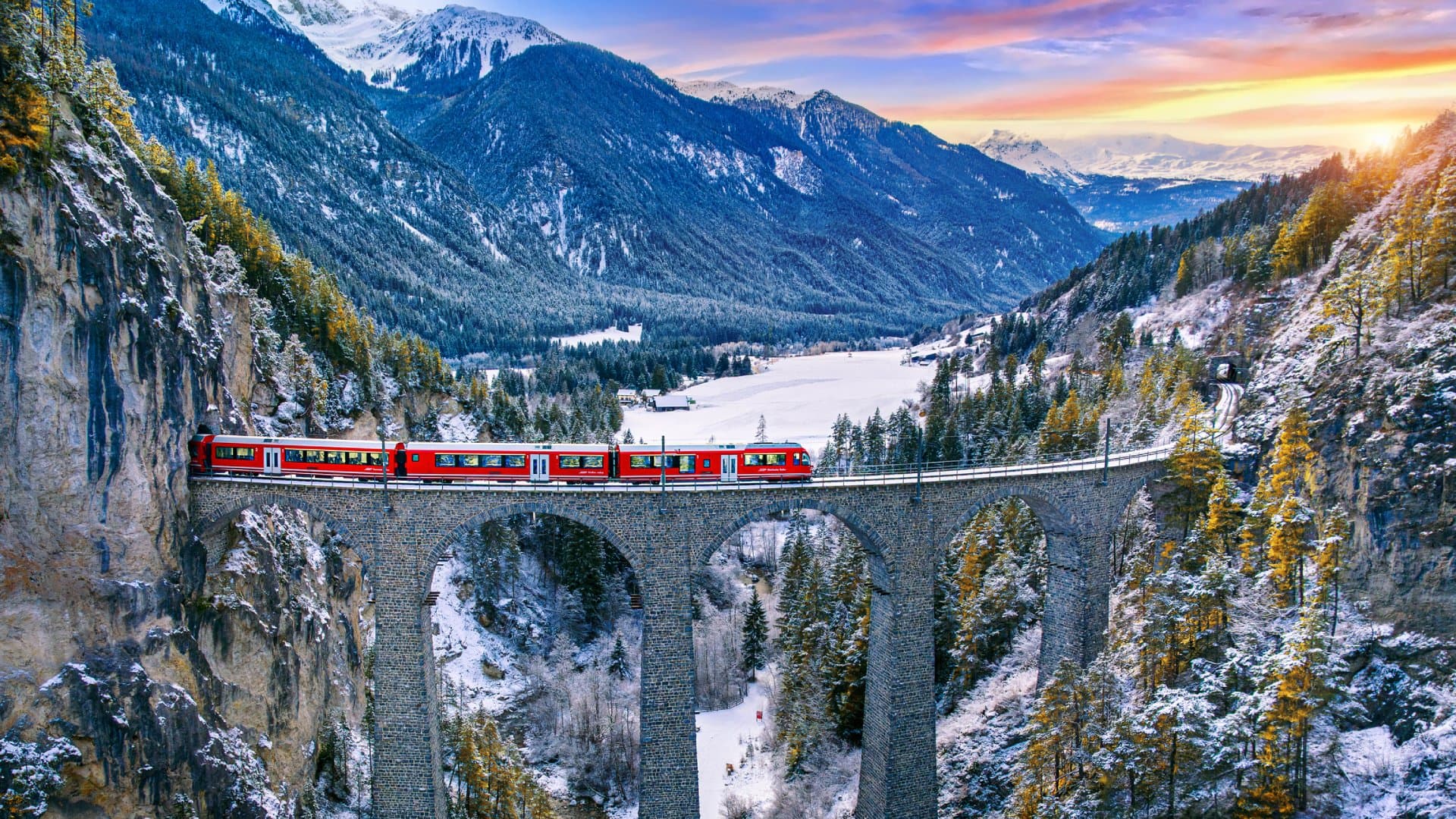Aerial view of Train passing through famous mountain in Filisur, Switzerland. Landwasser Viaduct world heritage with train express in Swiss Alps snow winter