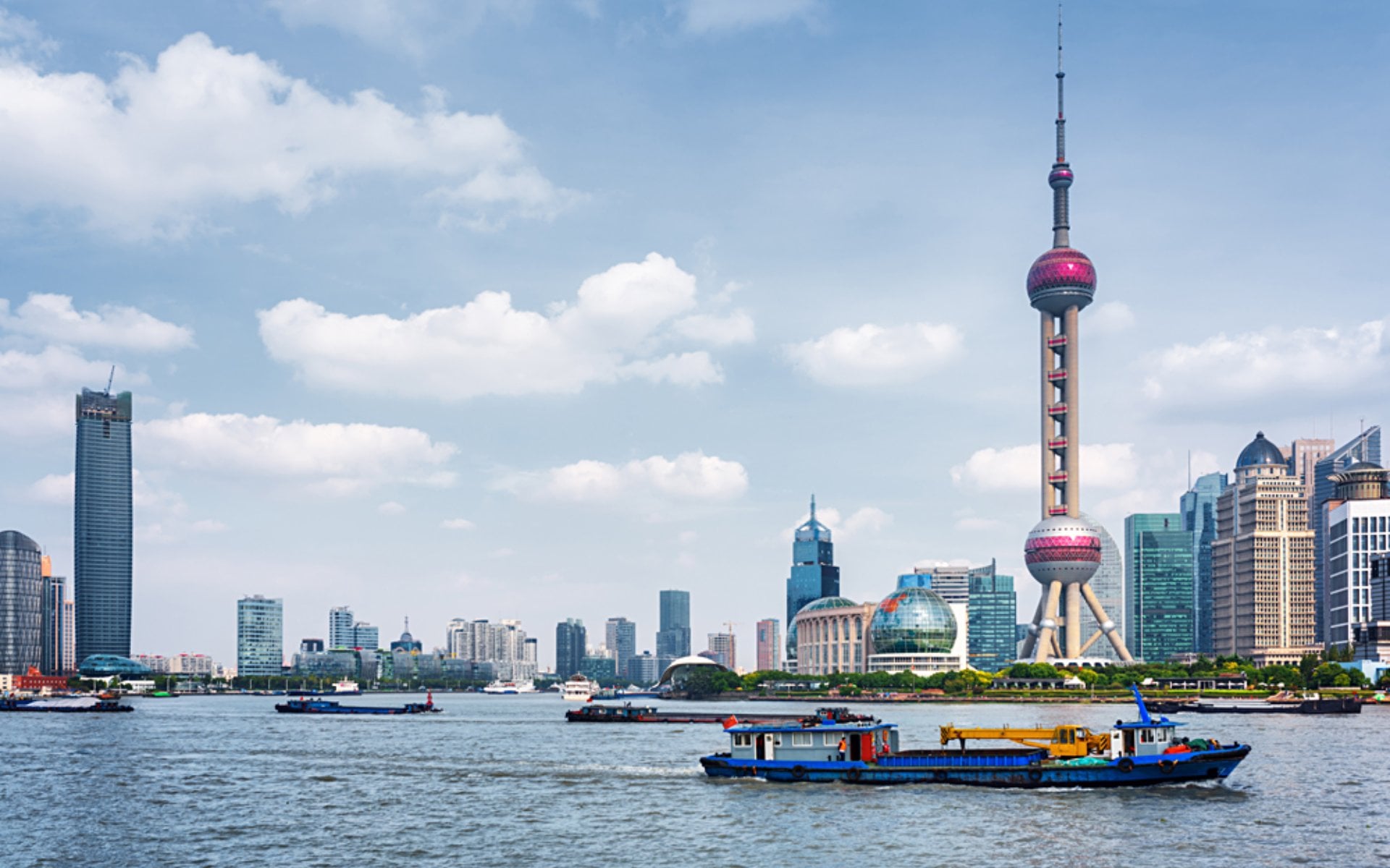 Boats crossing the Huangpu River in Shanghai, China