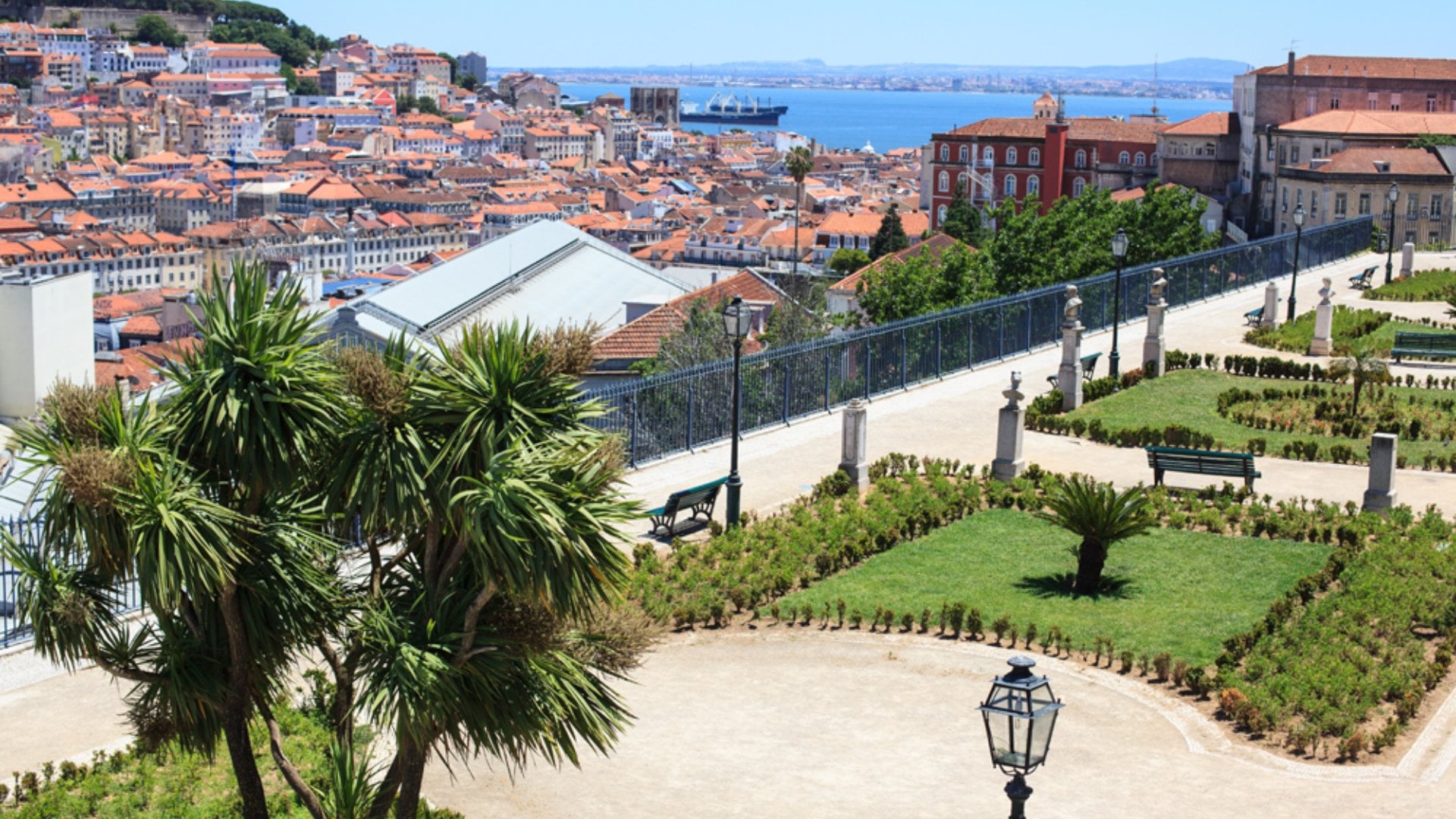Cityscape of park and Lisbon city from Sao Pedro de Alcantara viewpoint, Lisbon, Portugal