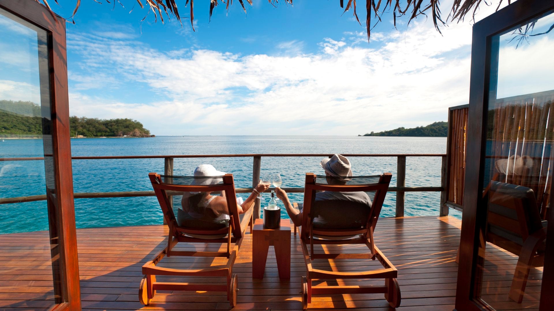 Couple relaxing in an over water bungalow