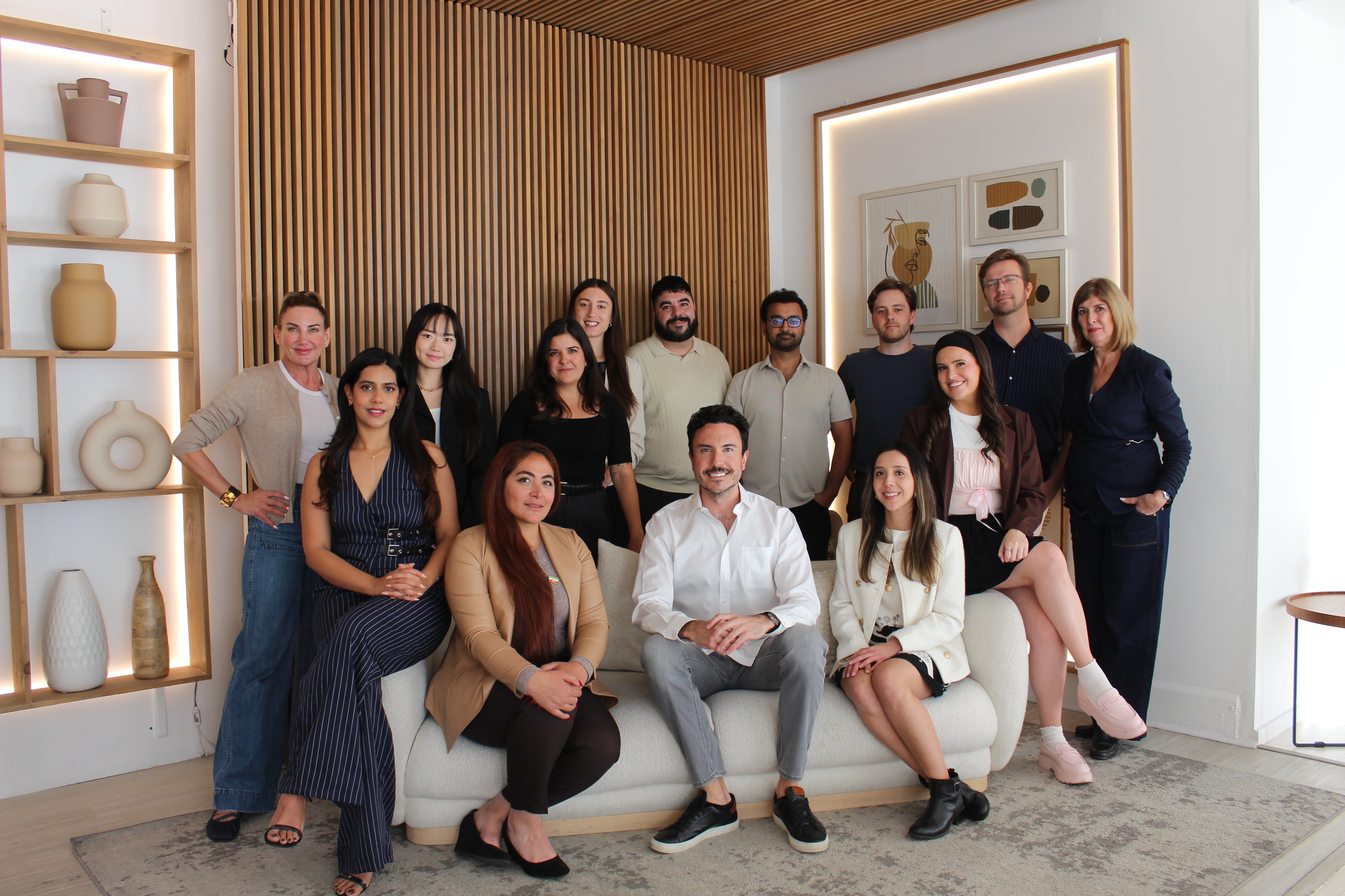 Globetrotting magazine editorial team of writers, editors and designers posing together in the Goway Travel office in Toronto