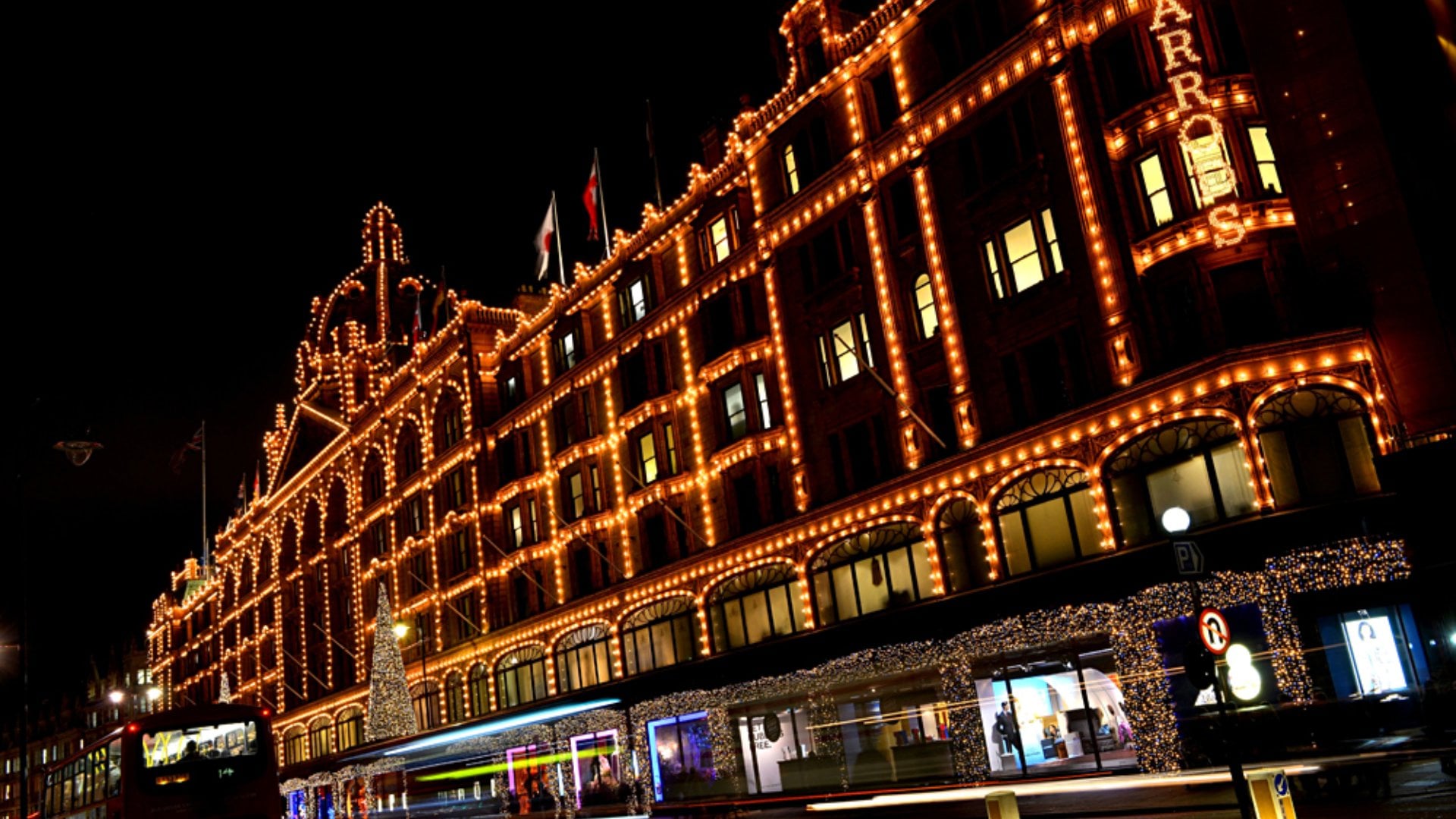Harrods lit up at night, Knightsbridge, London, England, UK