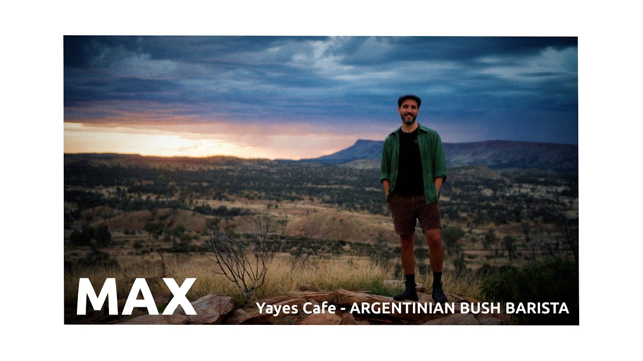 Max of Yayes Cafe standing on a hilltop at sunrise in Alice Springs, Norhtern Territory, Australia.
