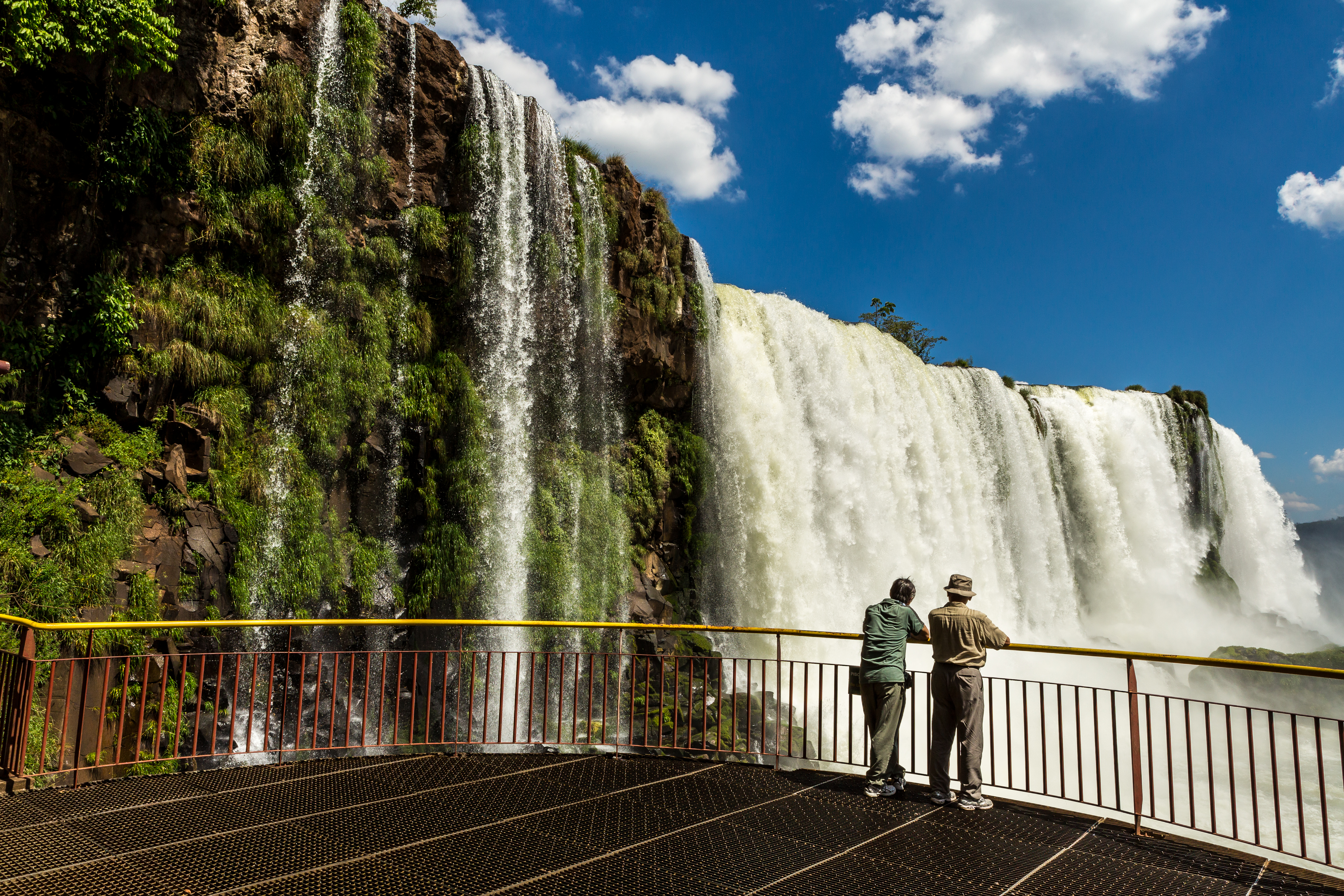 Two people overlooking Igacus Falls, Brazil.