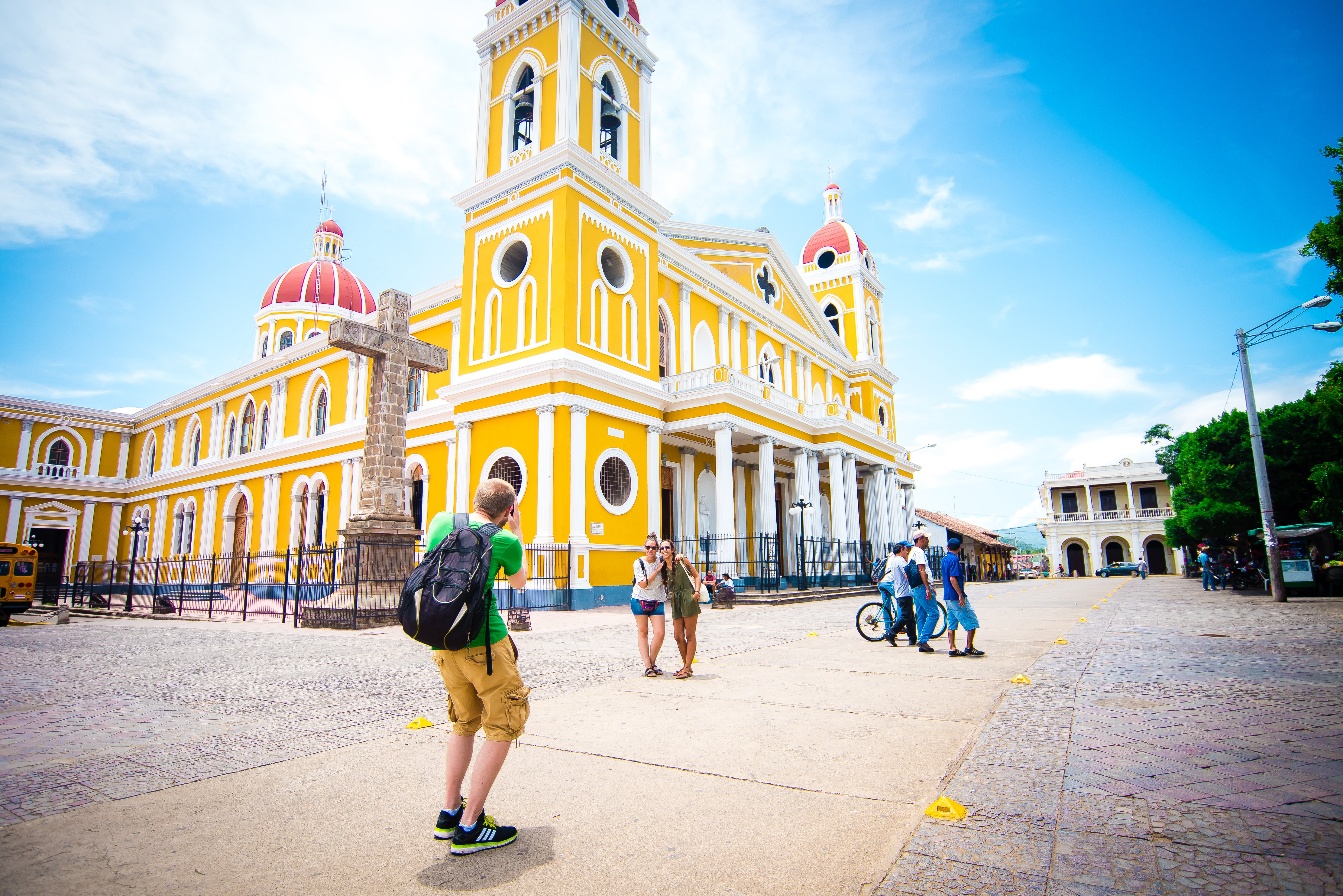 Tourists taking a photo outside of the Granada Cathedral, Granada, Nicaragua.