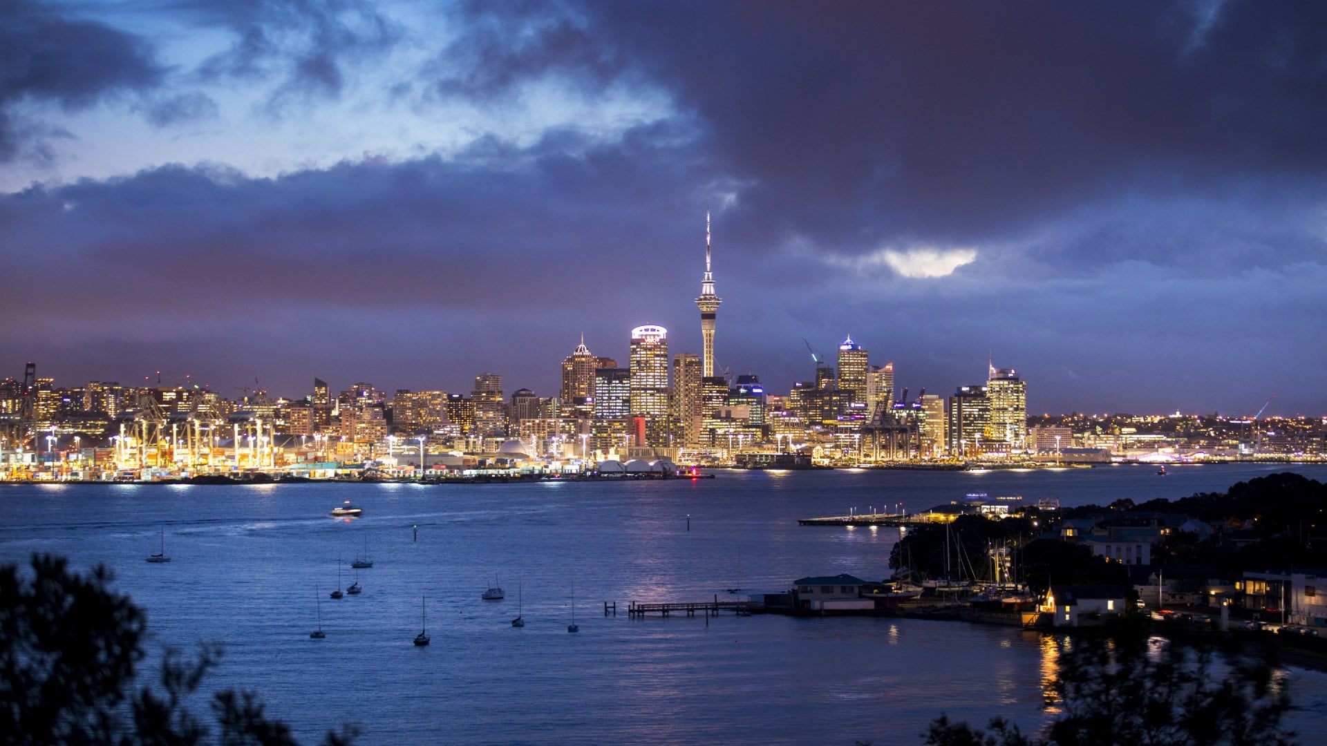 The skyline of Auckland, New Zealand comes to life just after sunset.