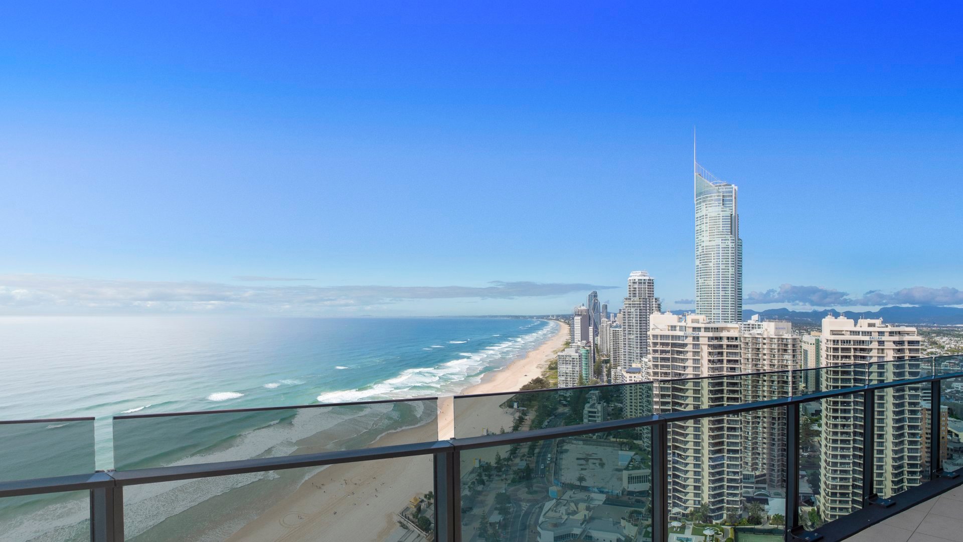 view from a balcony over city along the ocean