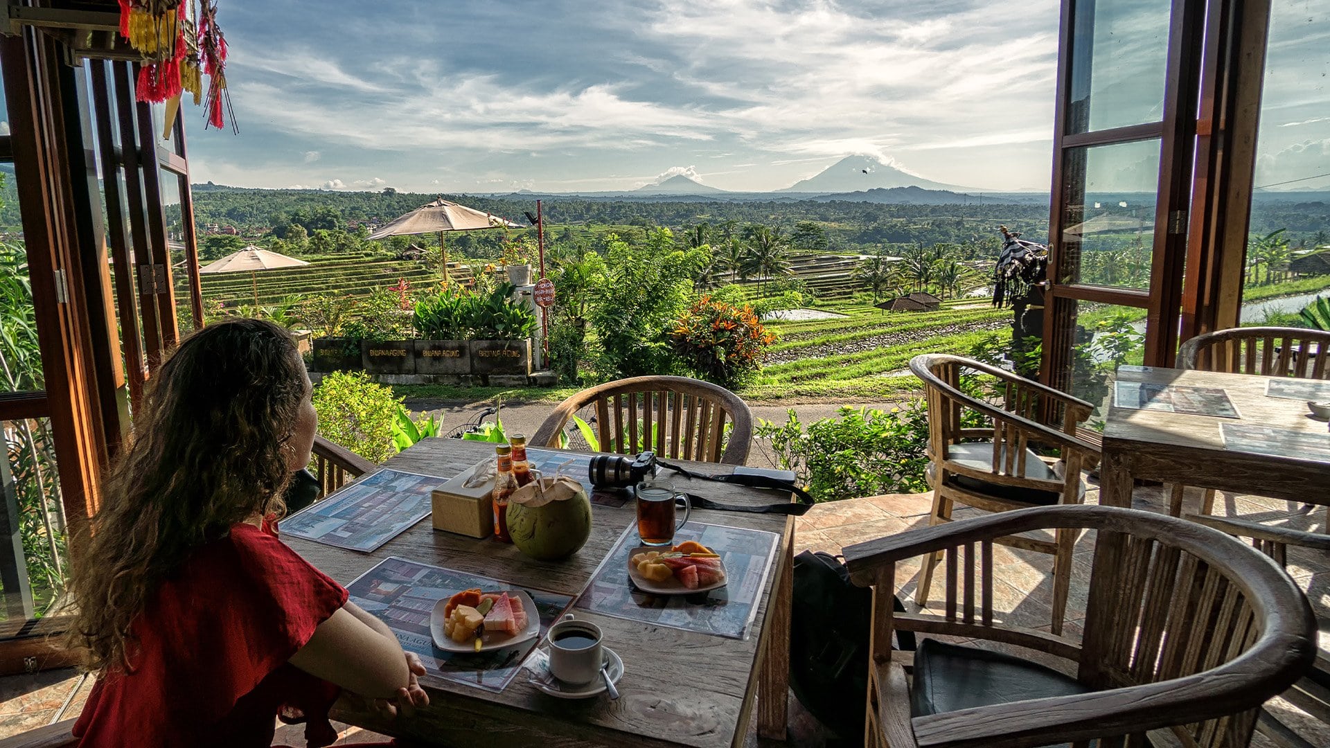 woman having lunch overlooking rice paddies and mountains