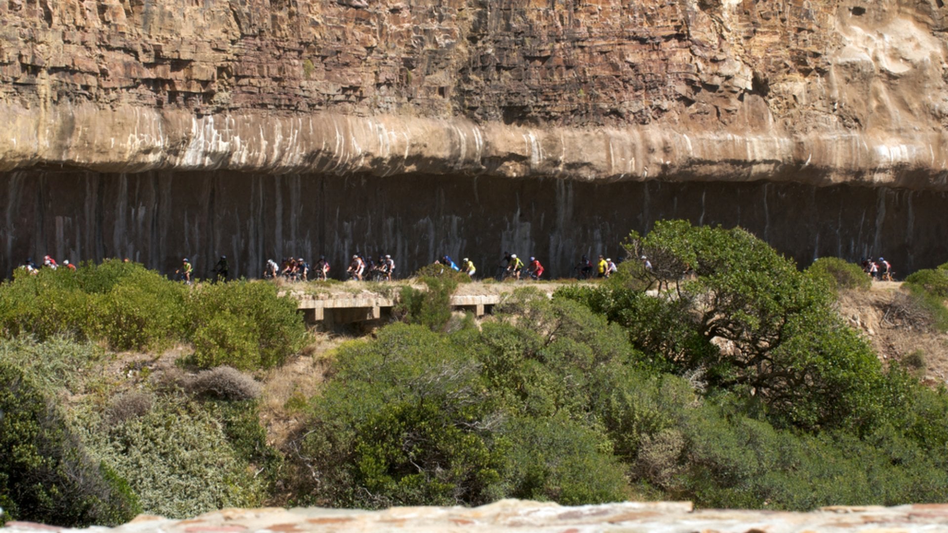 Cyclists pass through a tunnel on Cape Argus