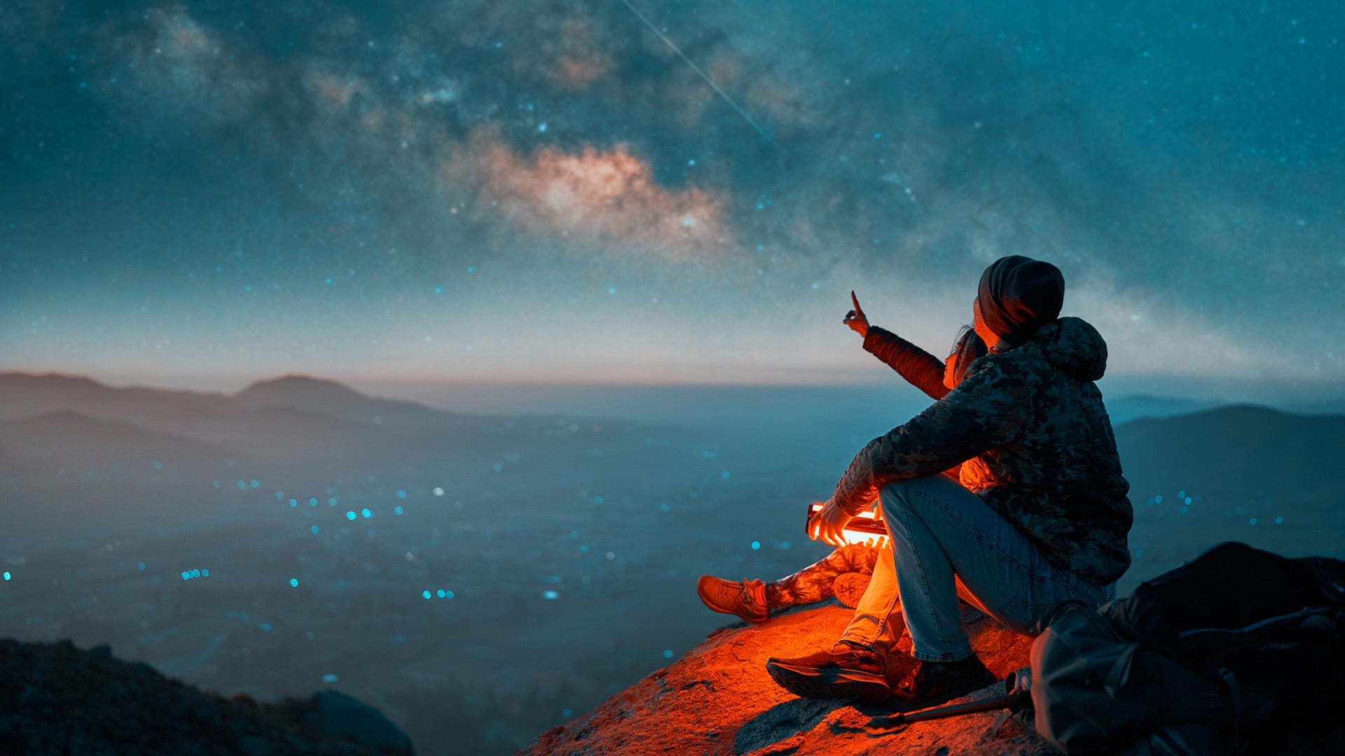 A couple stargazes from the top of a mountain in Chile.