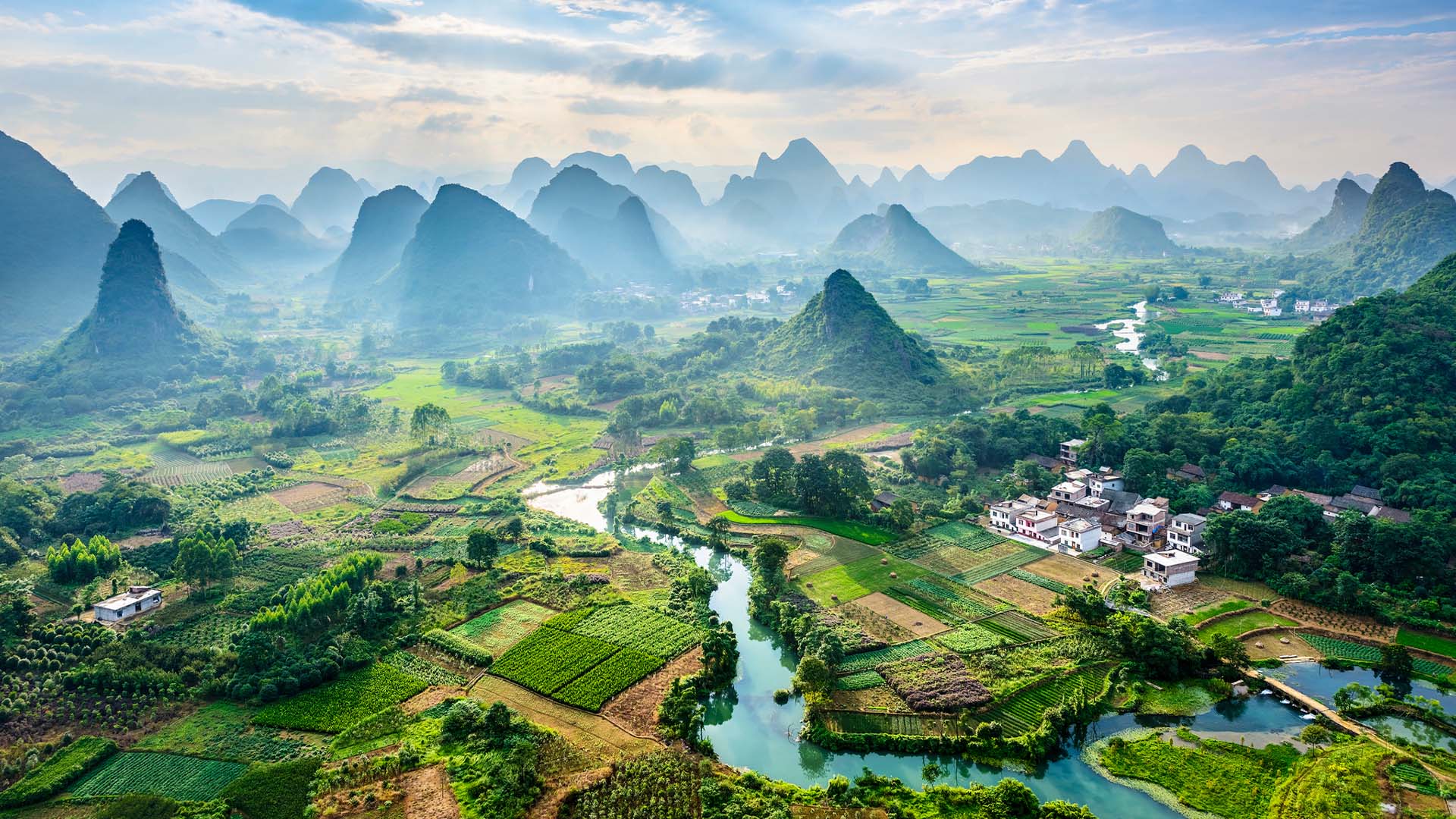 Aerial view of the rice paddies, mountains, and river in Guilin, China.