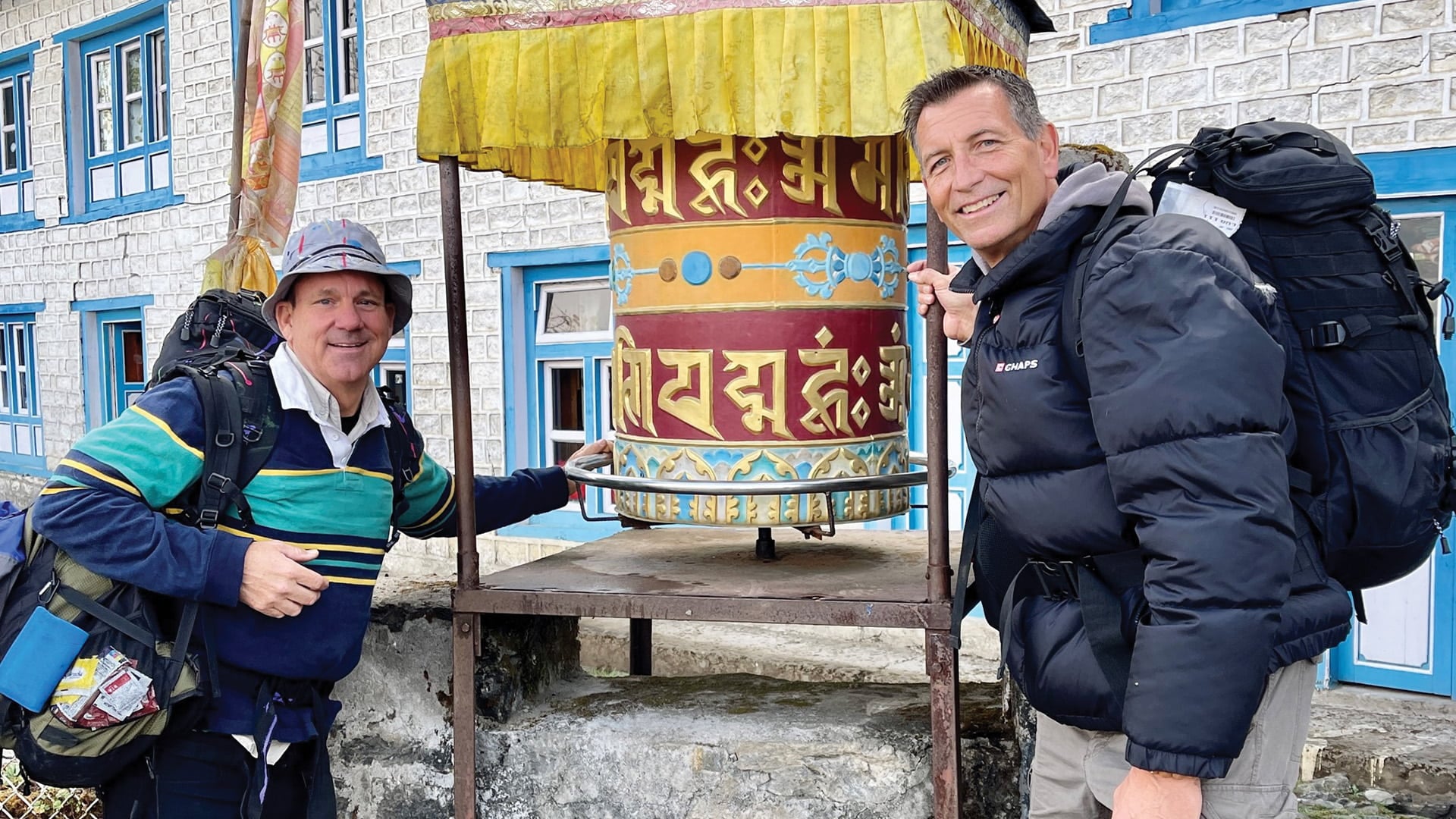 two men with prayer wheel in Nepal