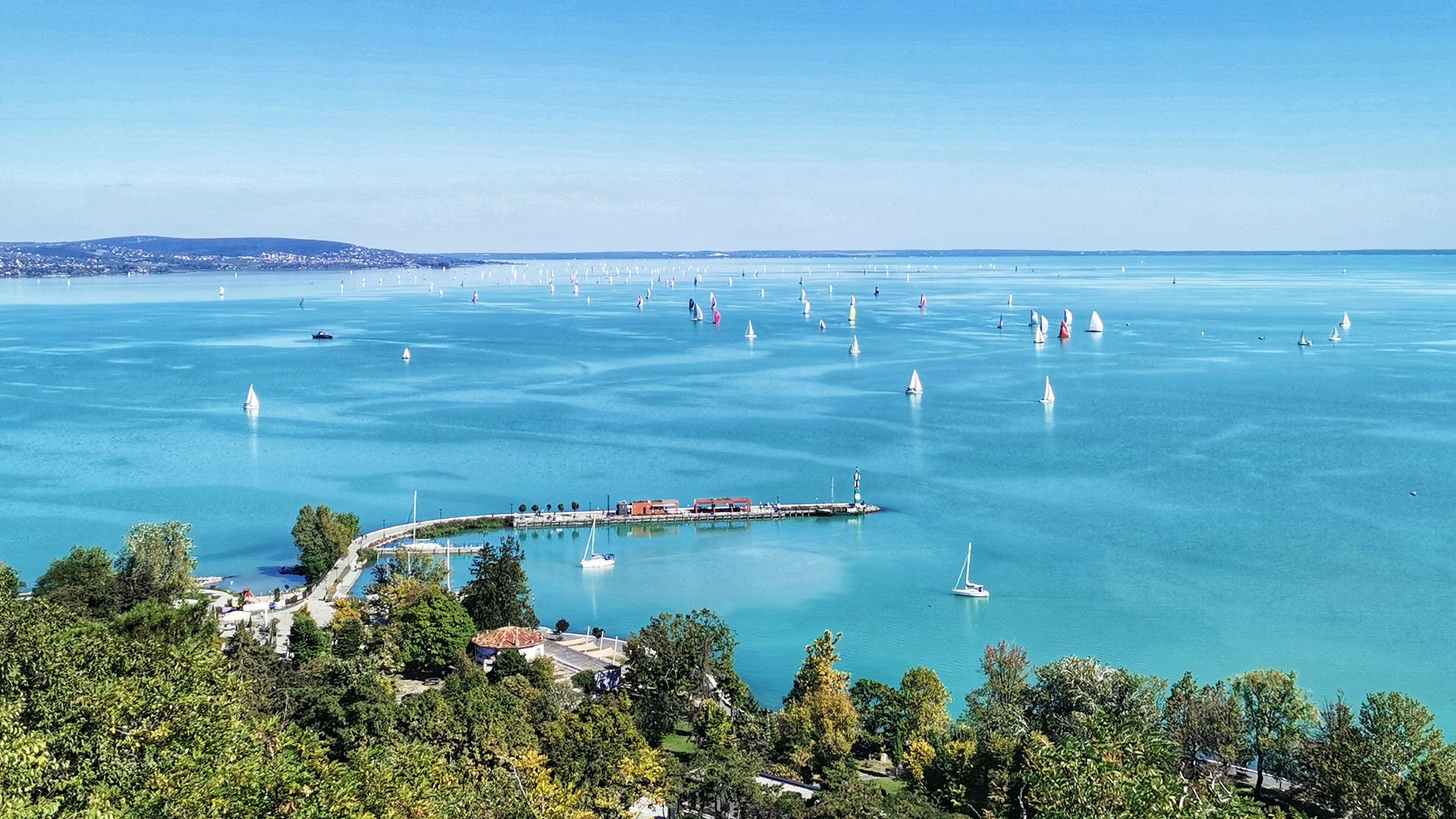Panoramic view of Lake Balaton with sailboats on the clear water in Hungary