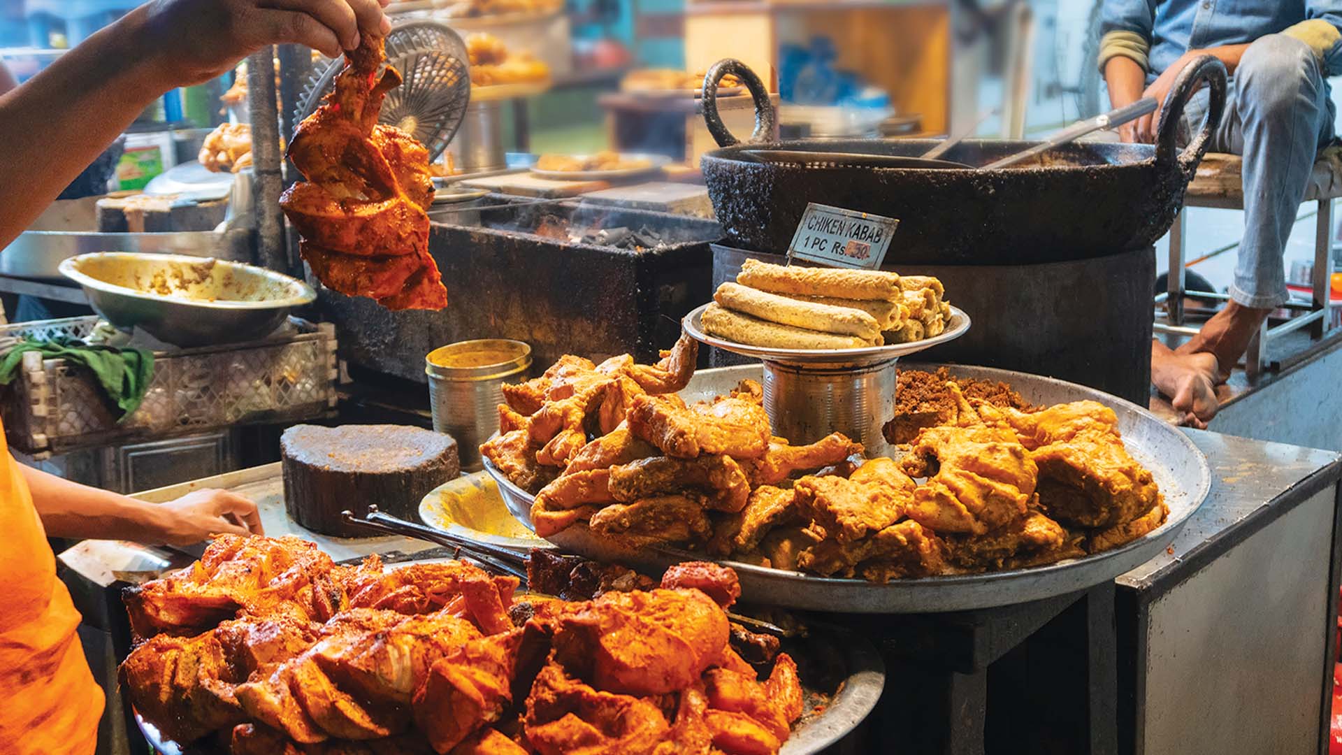 Street vendors in Delhi selling tandoori chicken and other treats