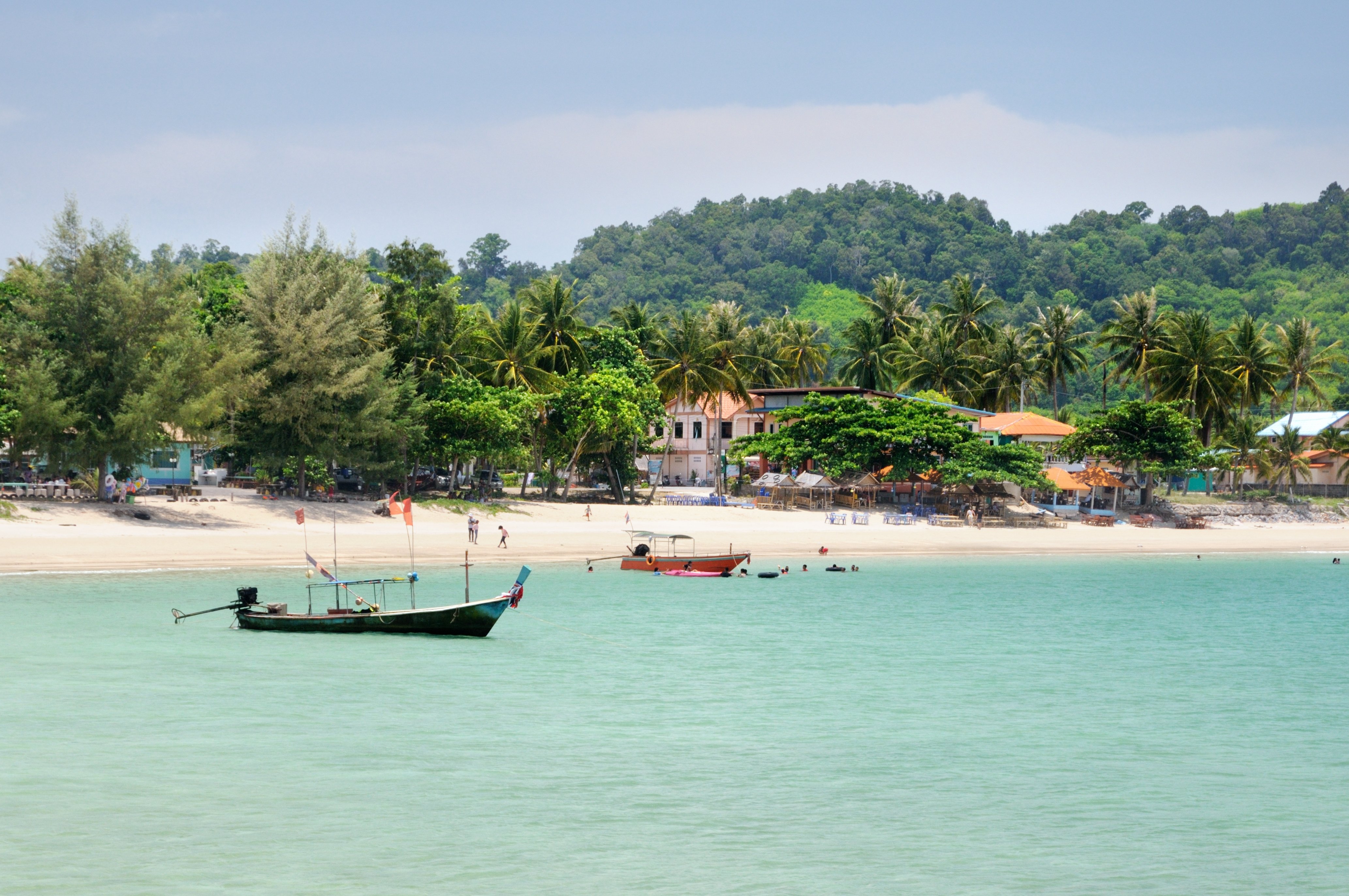 Tropical turquoise sea bay, paradise sandy beach, palm trees, tourist resorts in Thailand