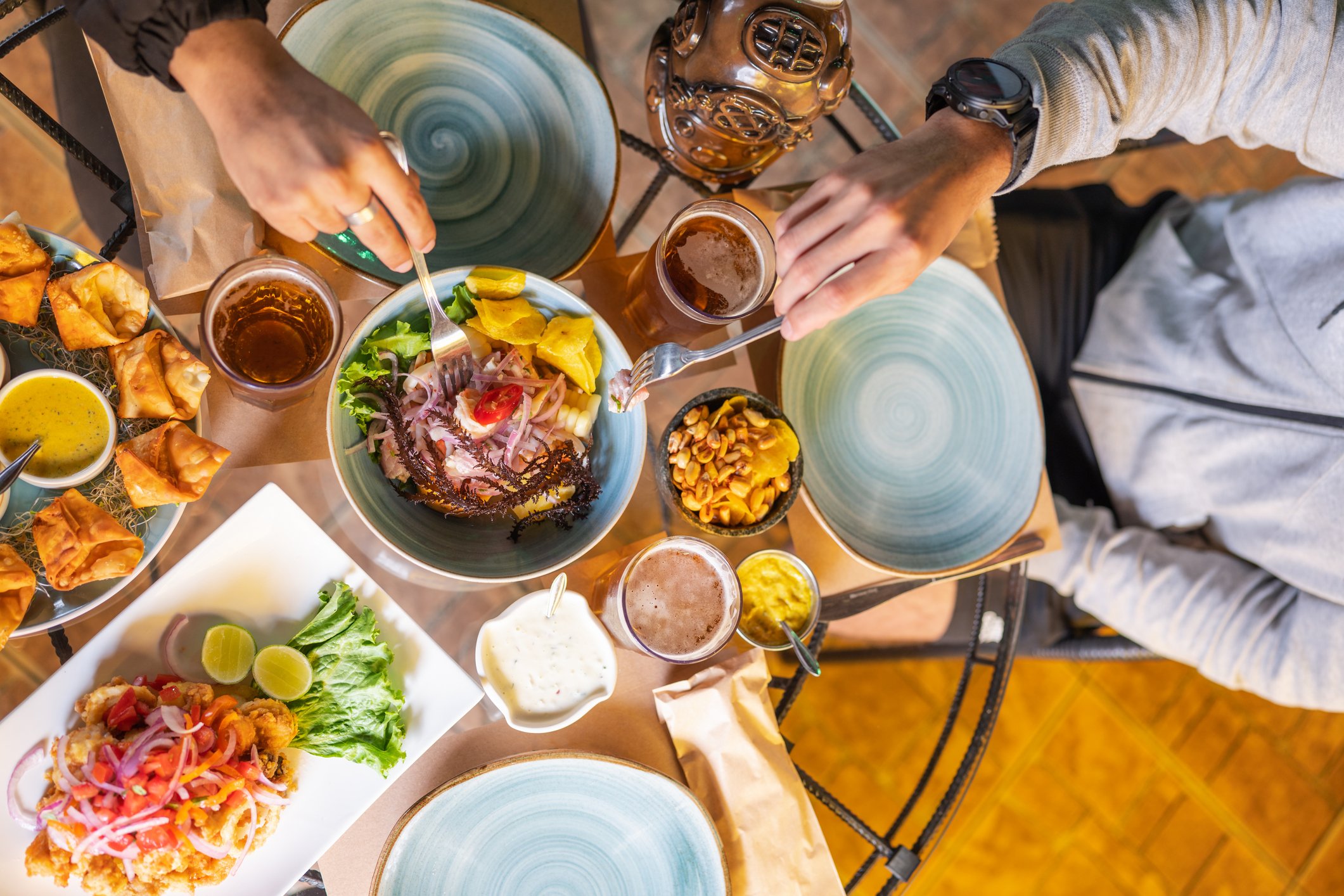 Top view of a table of a restaurant with customers eating peruvian dishes in Peru.