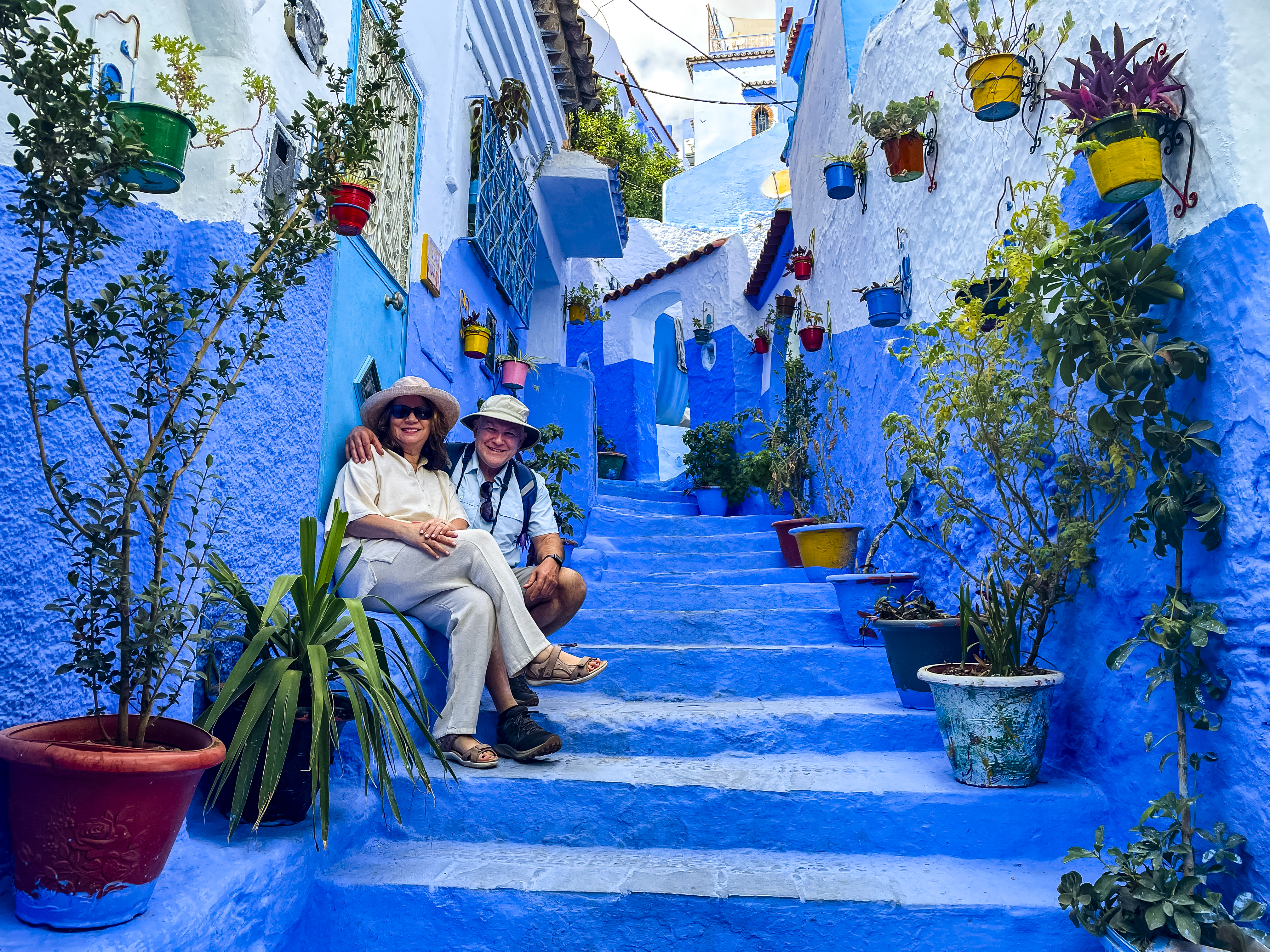 A smiling couple in a blue hallway, Morocco.