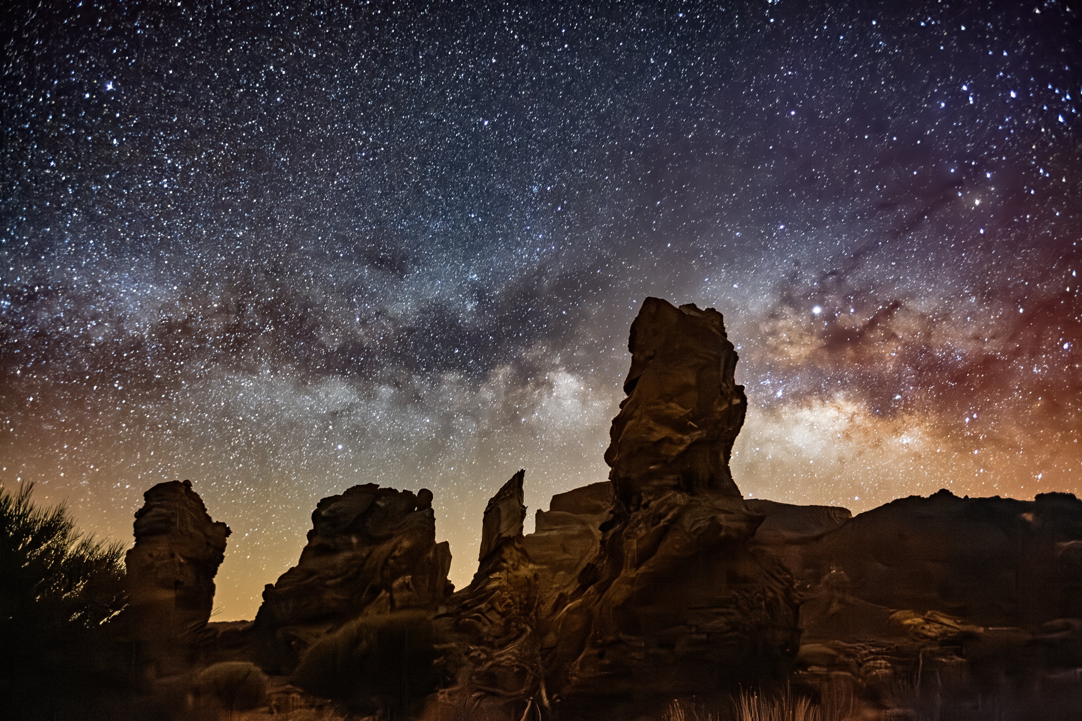 Majestic night sky with Milky Way above rock formations Roques de Garcia in a desert landscape of Tenerife.