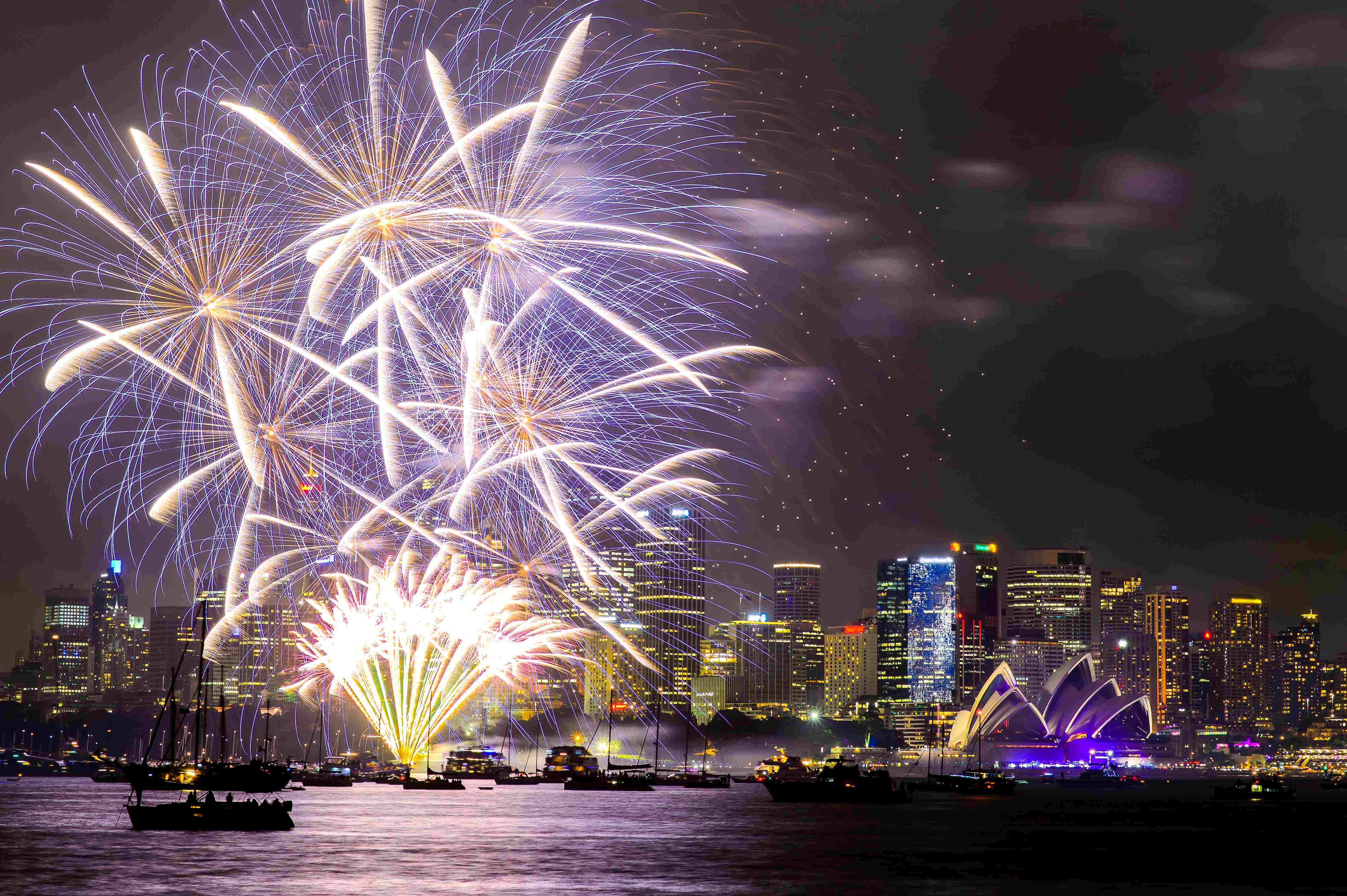 A spectacular display of fireworks over the Syndey Harbour on New Years Eve, with the Sydney Opera House in the bottom left corner of the shot, in Sydney, Australia.