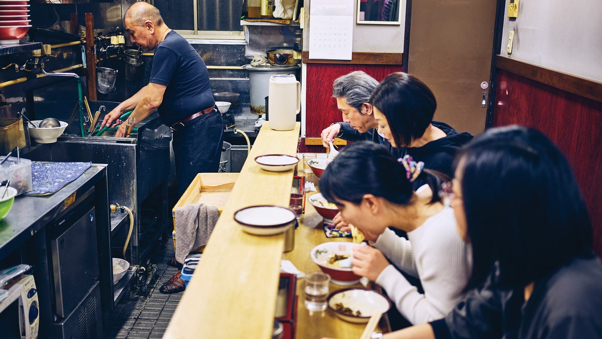 Diners eating inside a Tokyo ramen restaurant