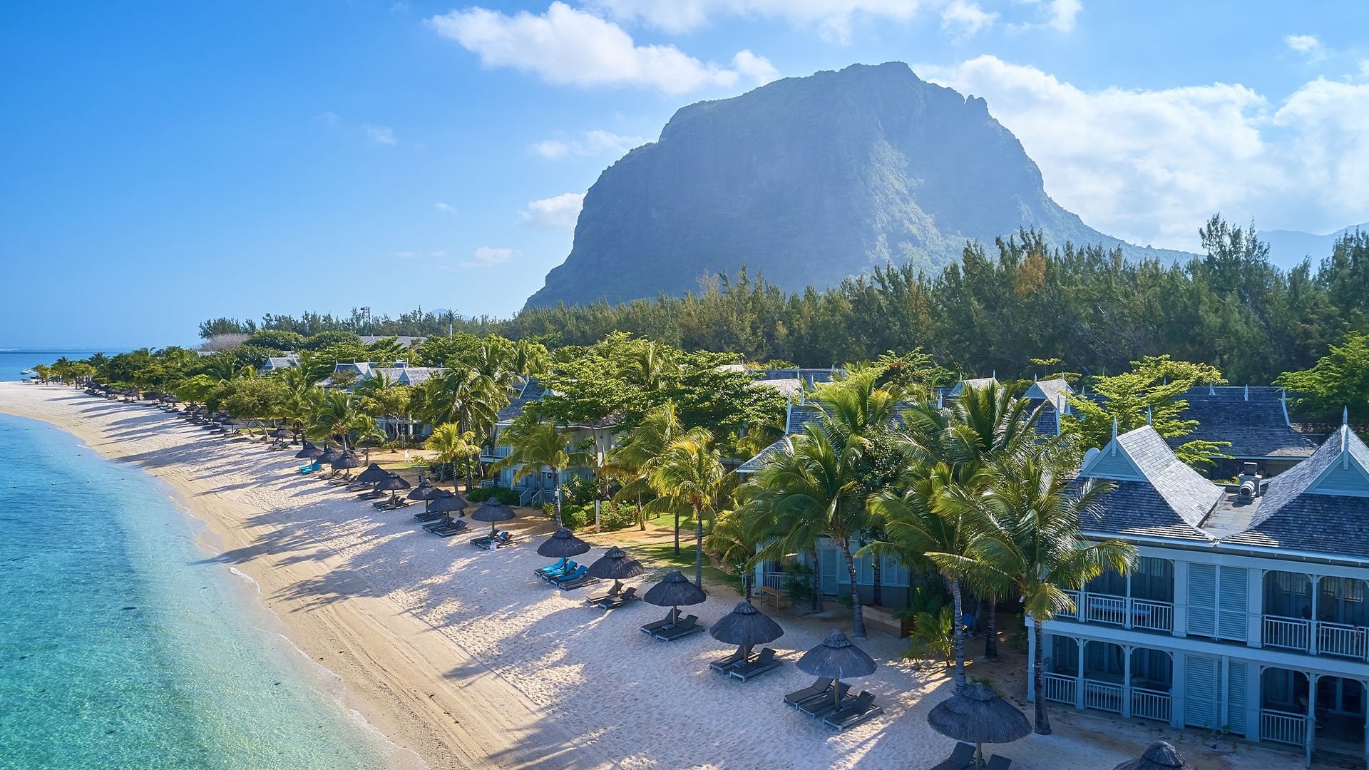 aerial view of pristine resort accommodation with backdrop of a mountain in Mauritius