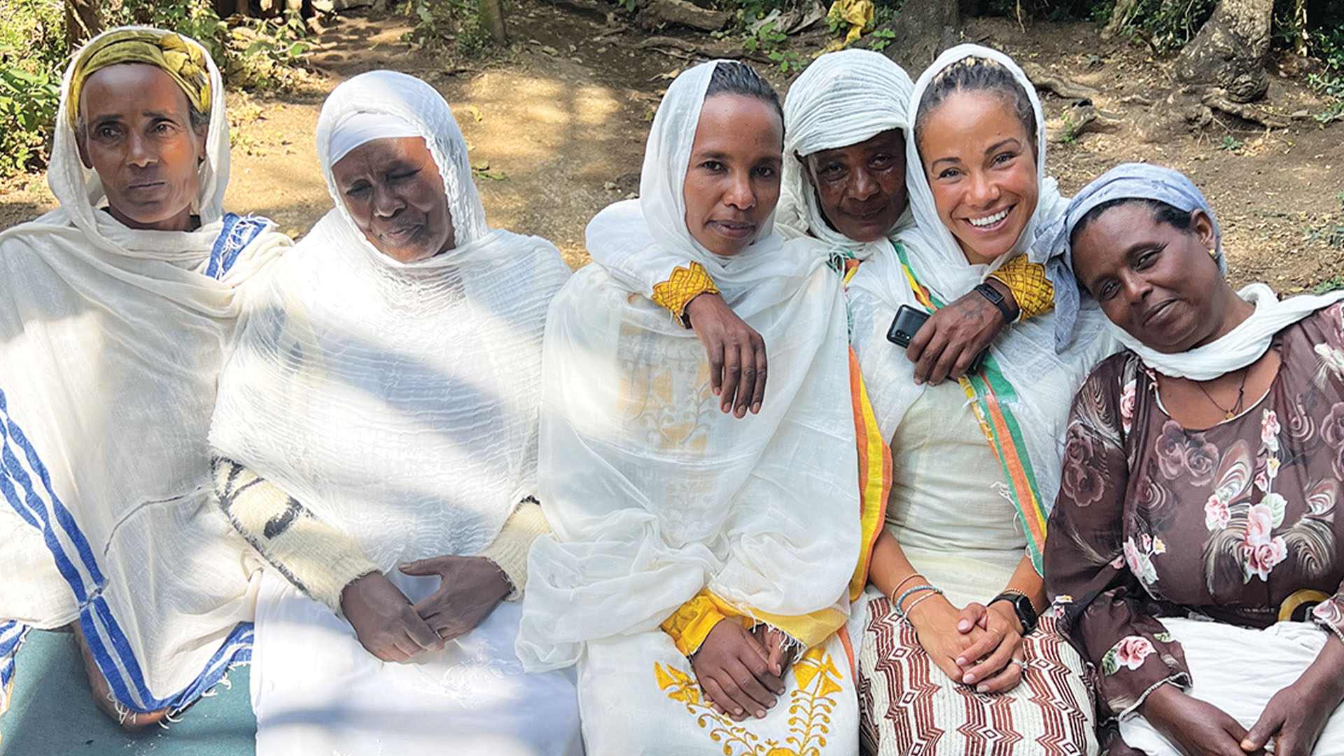 Natalie Peddie posting alongside the village women in Ada'a Ethiopia.